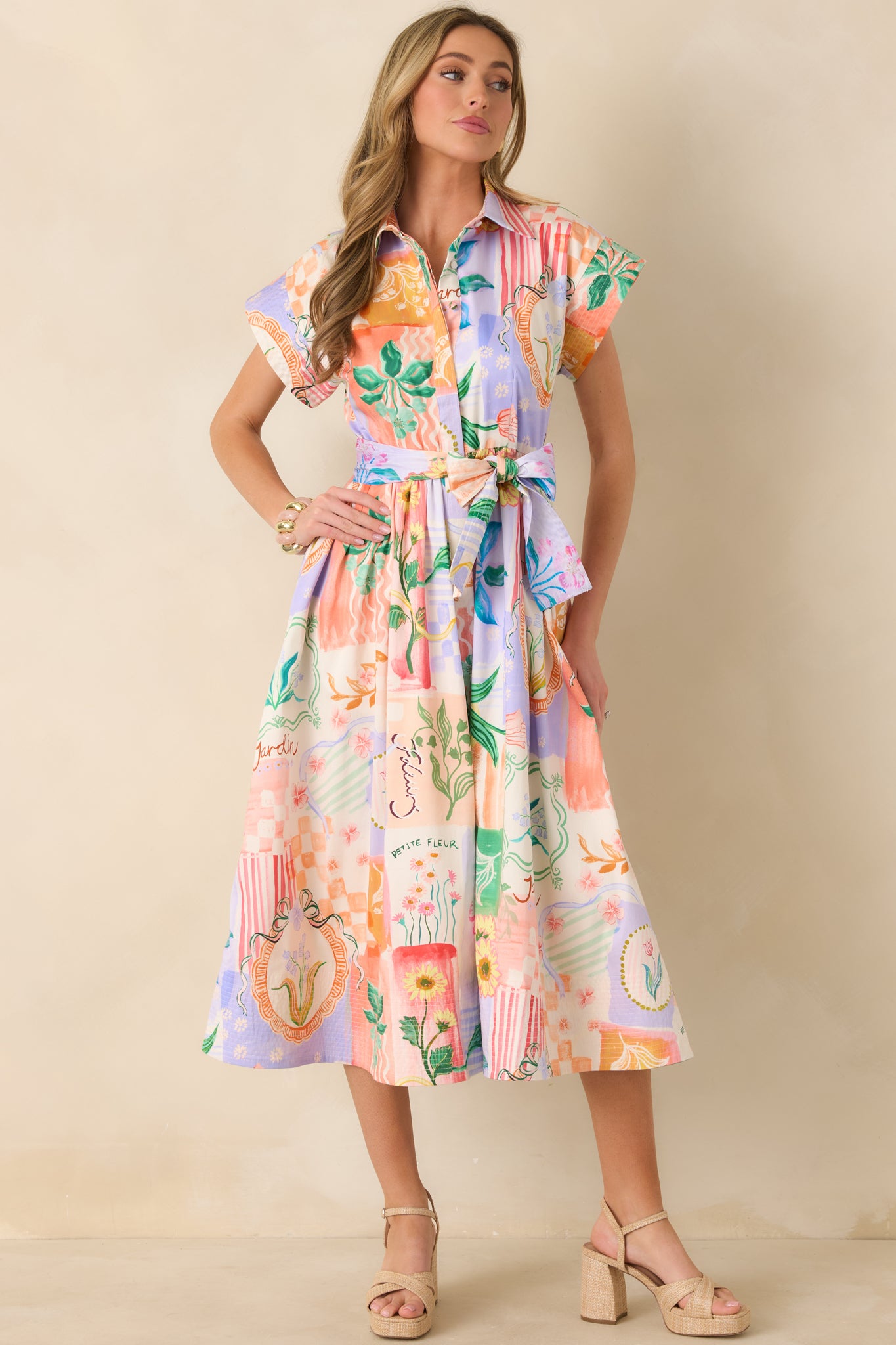 Mixed floral peach midi dress featuring short sleeves, a structured collar, and a button-front design with adjustable tie waist.