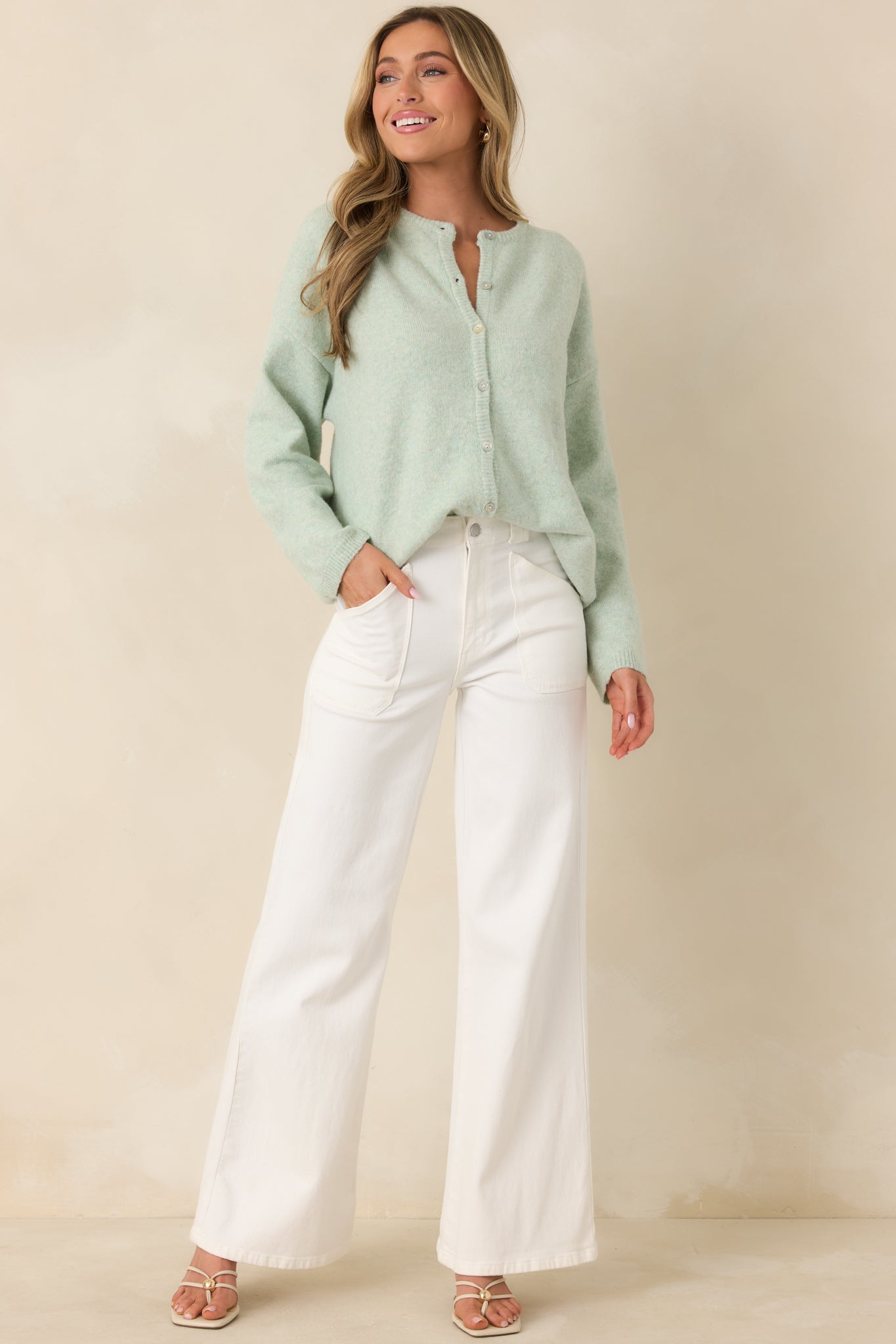 Cozy cardigan featuring ribbed trim at the neckline, cuffs, and hem, designed in a mint green knit with a clean silhouette.