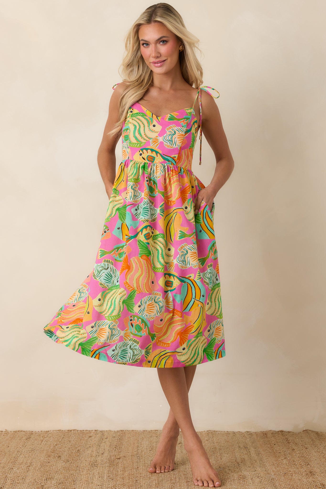 Breezy cotton midi dress with adjustable straps, gathered bodice, and flowing ocean-print skirt.