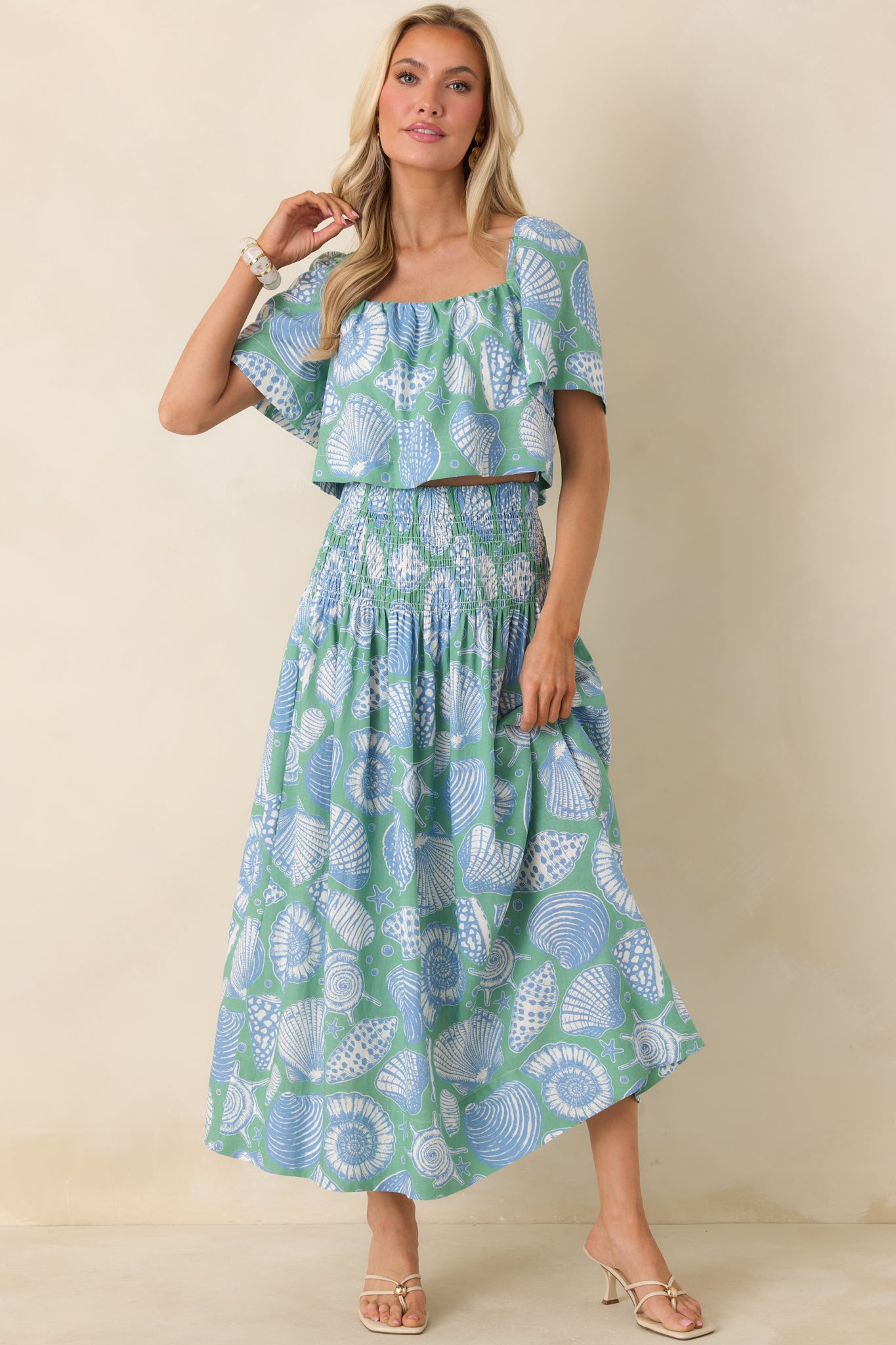 Green multi cropped top with a vintage seaside-inspired shell print and elasticized square neckline.