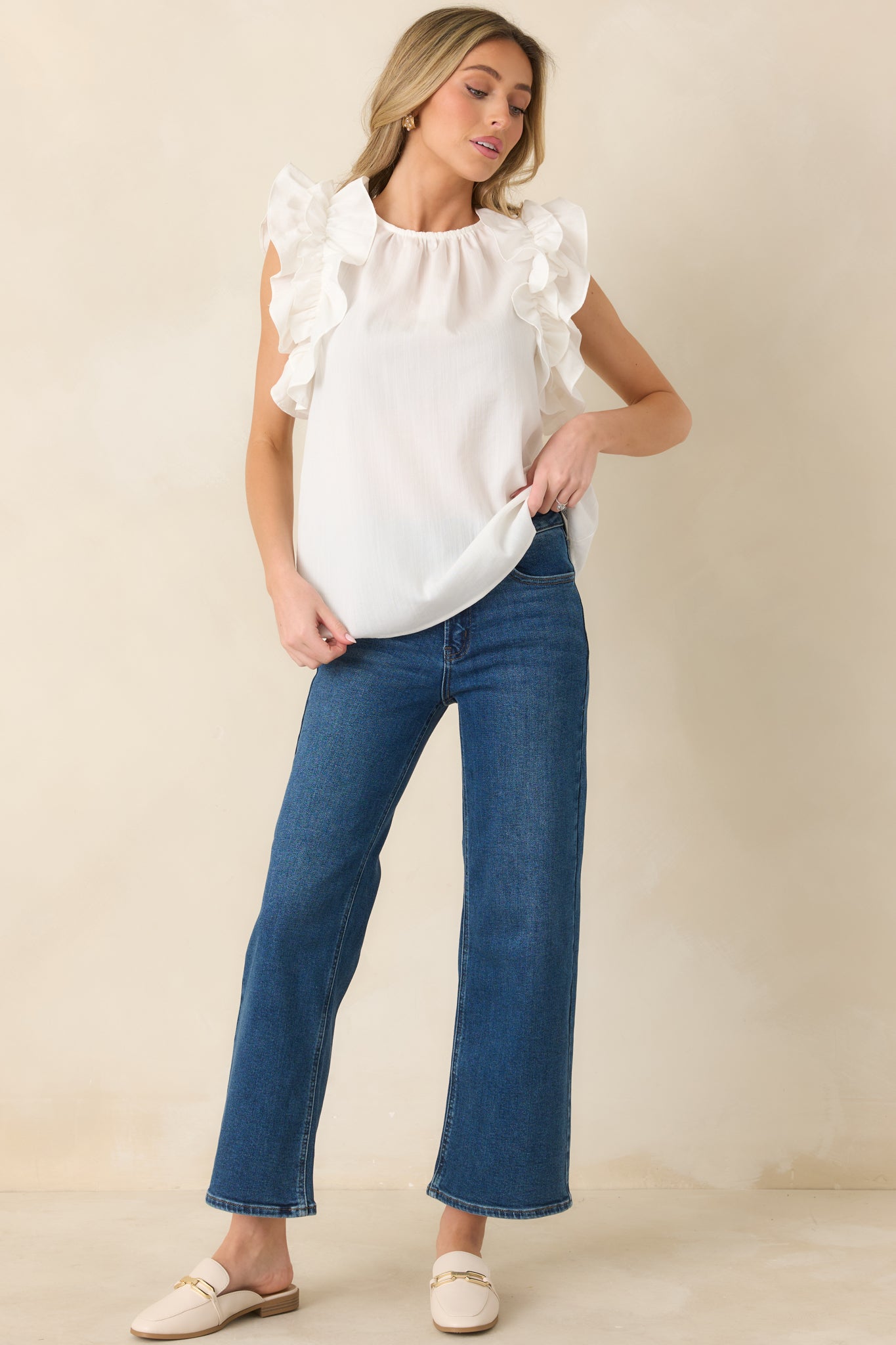 Front-facing angle of high-waisted dark wash jeans showcasing clean lines and cropped ankle length.