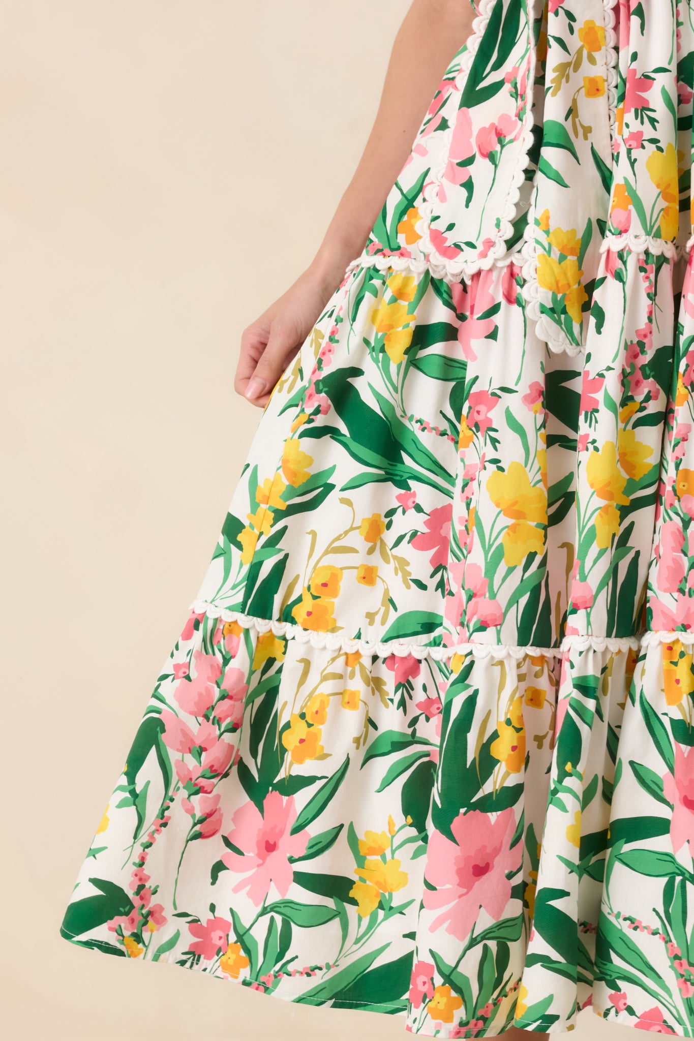 Close-up of floral cotton fabric highlighting scalloped trim.