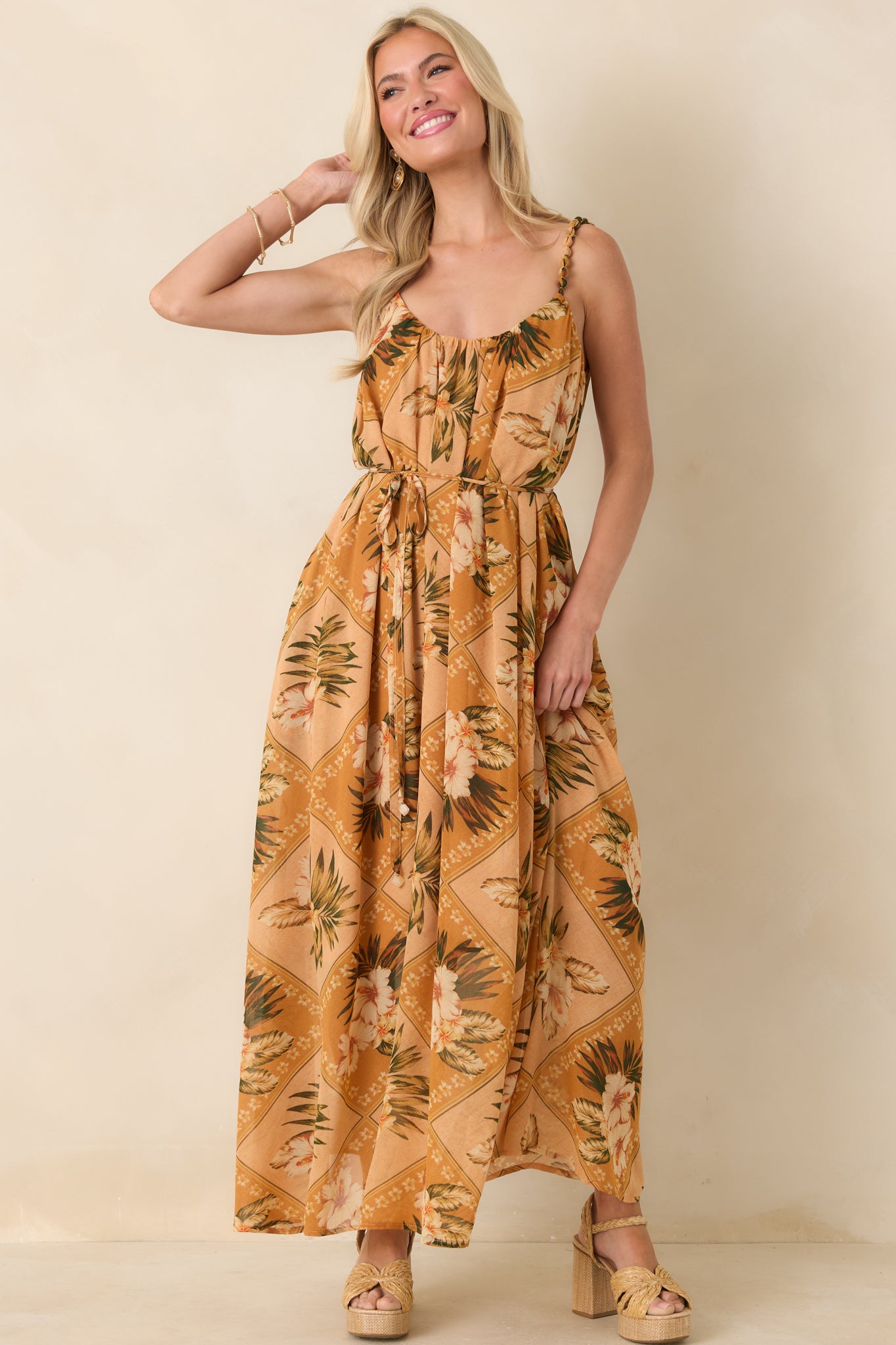 Peach, ivory, and green botanical print maxi dress with softly gathered neckline and beaded straps, shown front-facing.