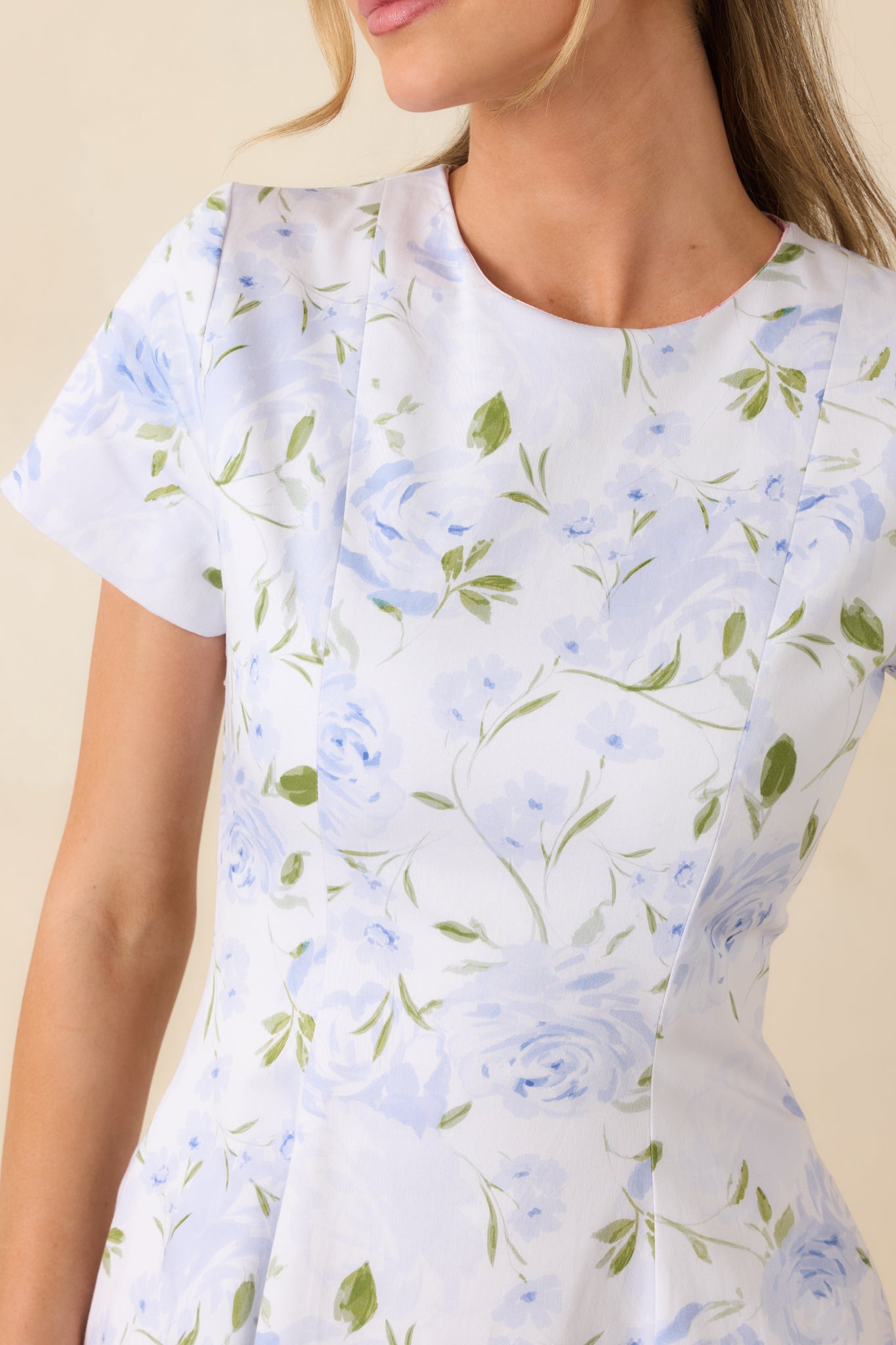 Blue floral fabric detail highlighting smooth finish, round neckline, and reversible construction.