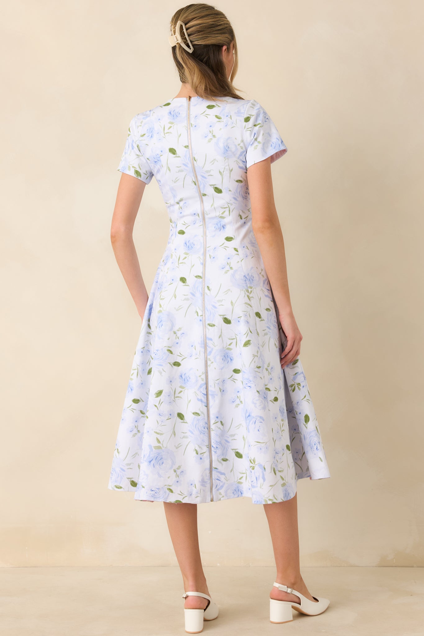 Blue floral midi dress with full-length metal zipper running from neckline to hem.
