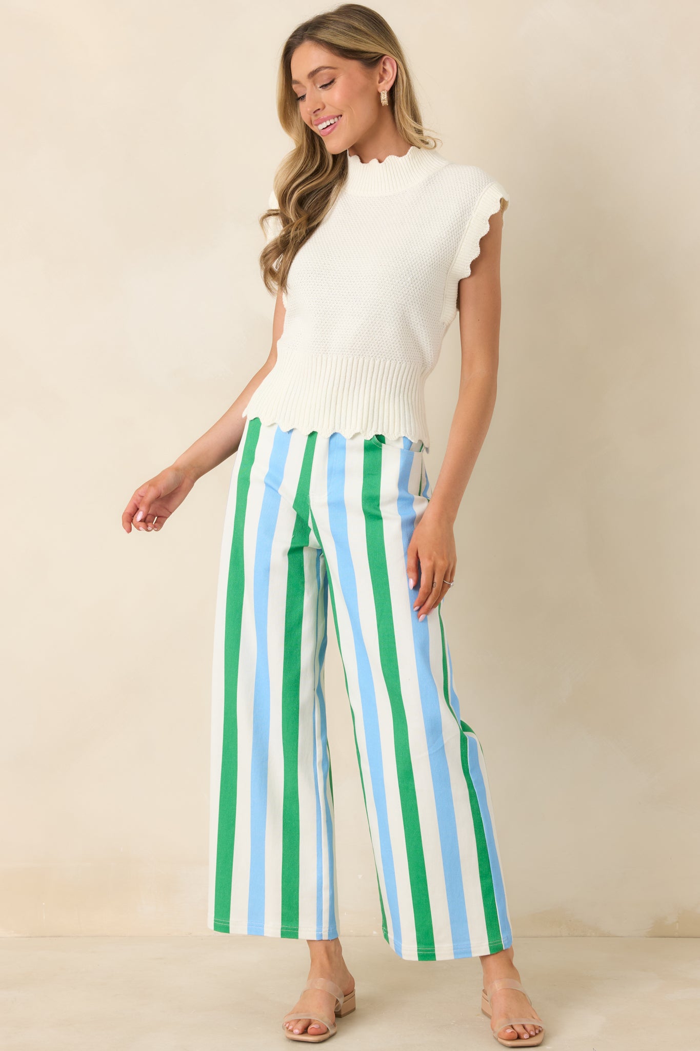 Striped high-rise pants in green, blue, and white featuring belt loops, functional front pockets, and a relaxed wide leg fit.