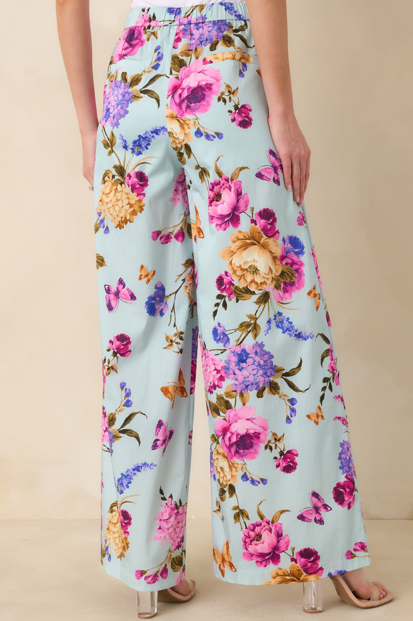 Back view of the blue wide leg pants highlighting the elasticized waistband and full-length relaxed silhouette.