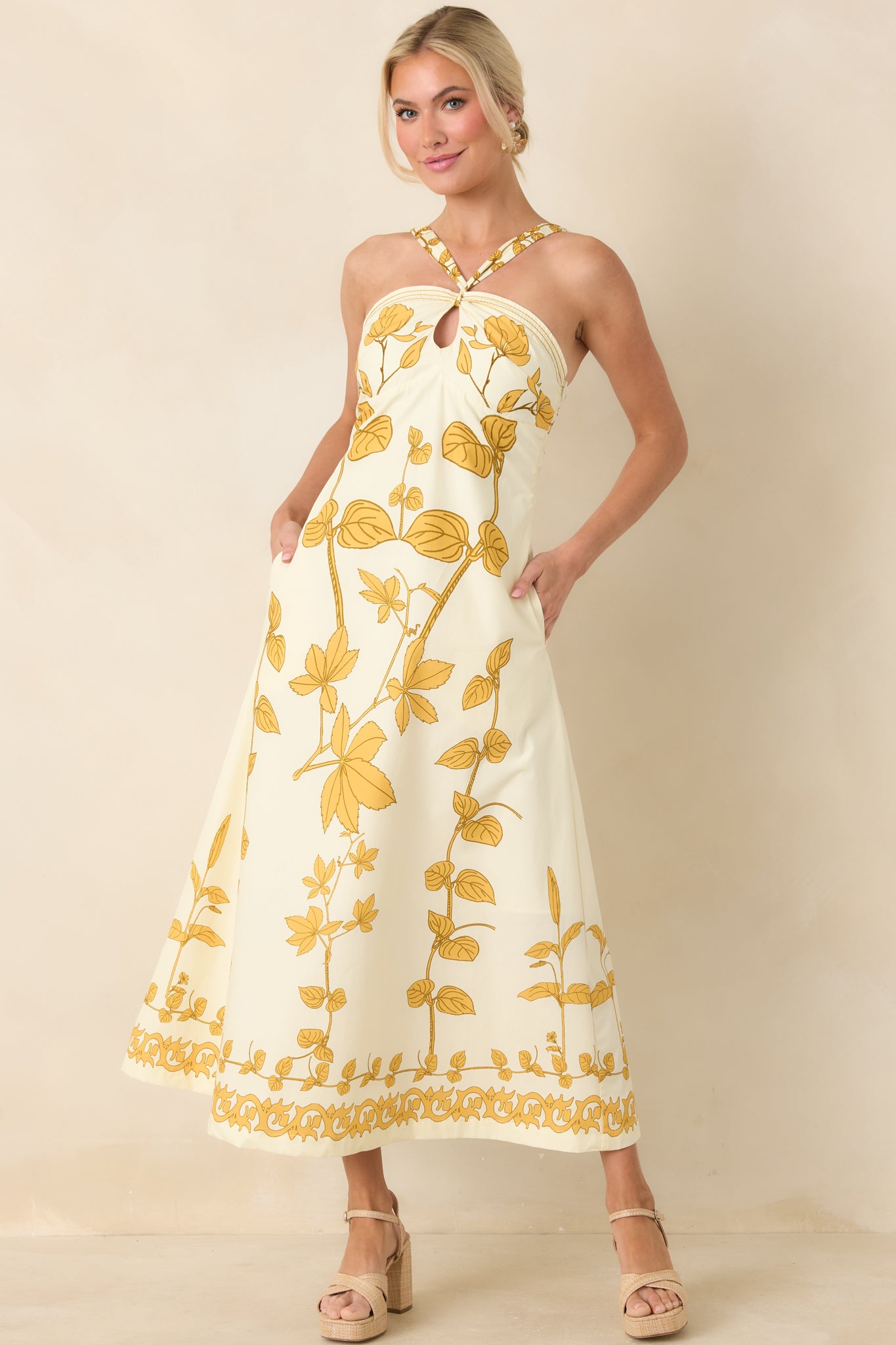 Full-length shot of floral maxi dress with refined border trim, flowing skirt, and modern yet classic color palette.