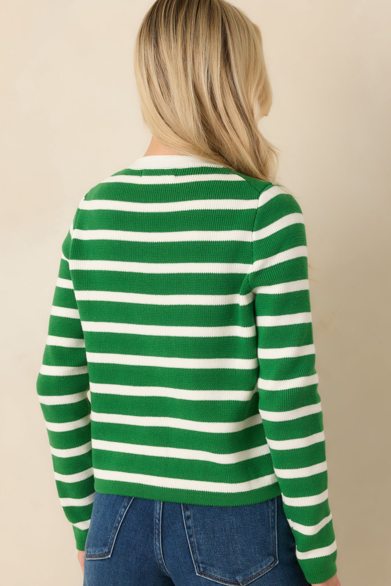 Back view of the green striped cardigan displaying the smooth back panel and long sleeve silhouette.