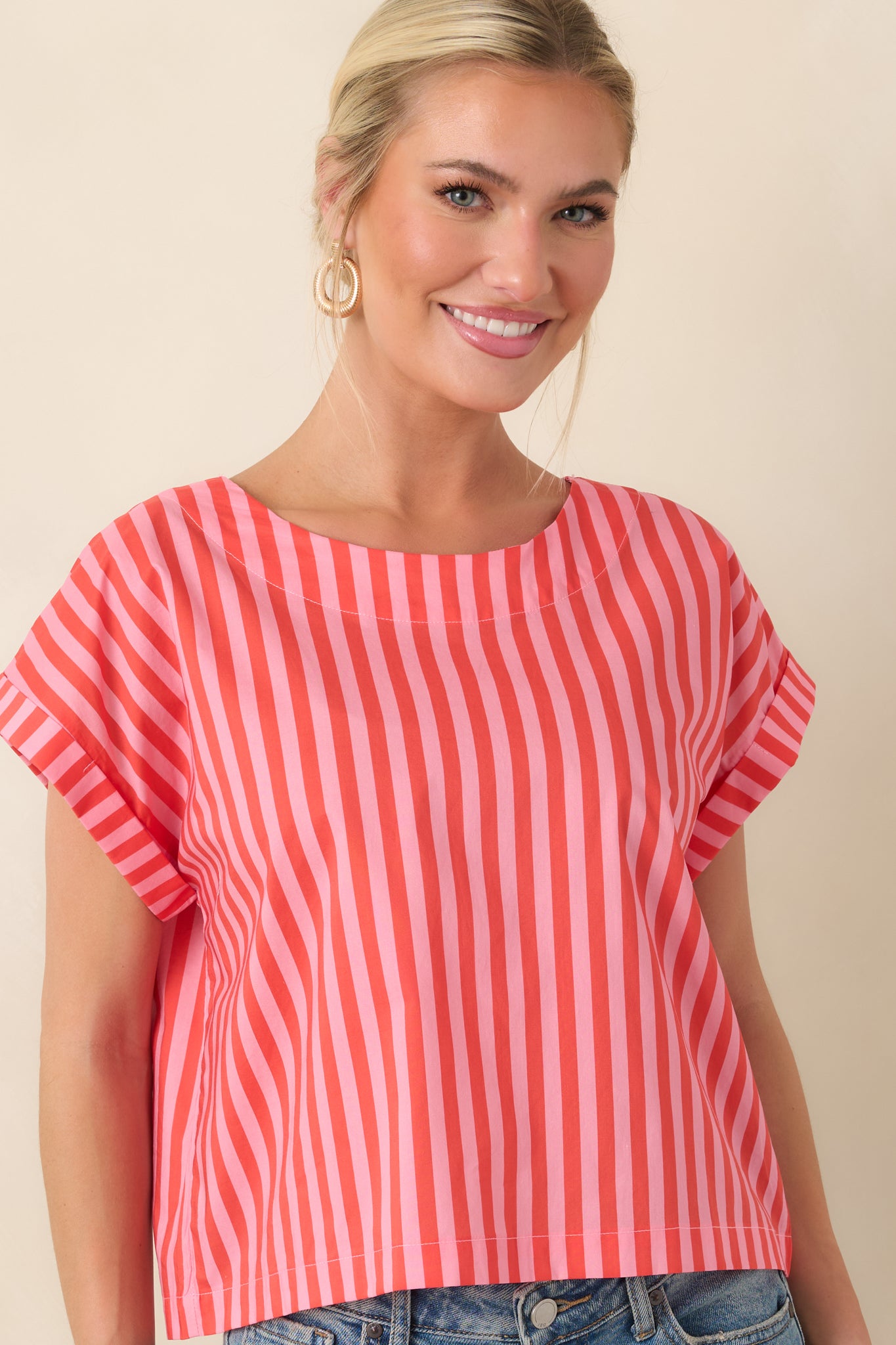 Vertical orange and pink stripe pattern on soft cotton fabric with a relaxed boxy structure and clean hemline.