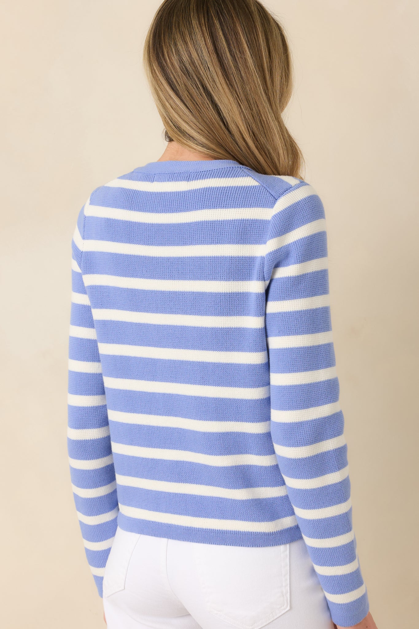 Back view of the blue striped cardigan showing the smooth back panel and long sleeve design.