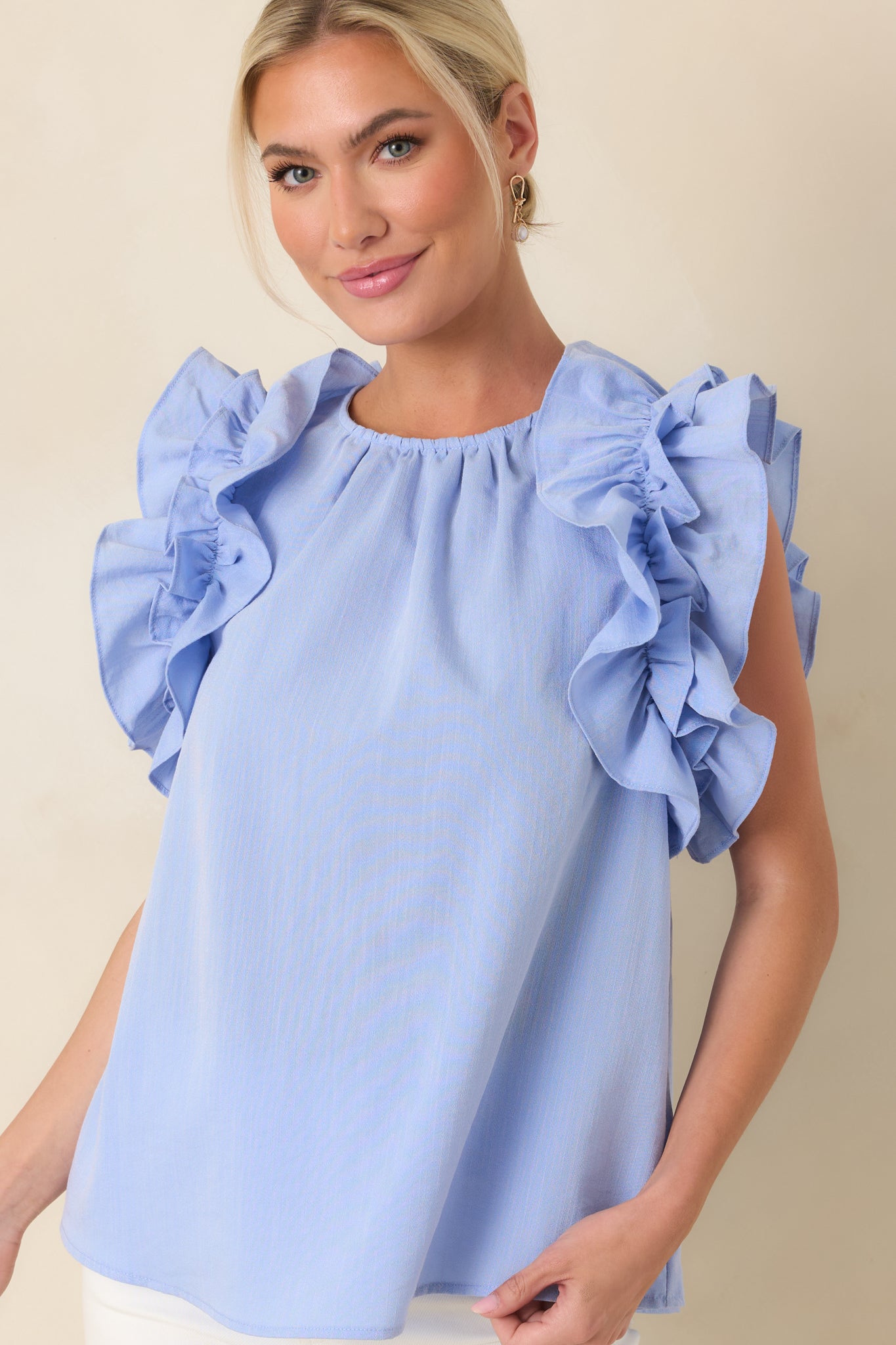 Shoulder ruffle layers in light blue with gentle gathered stitching.