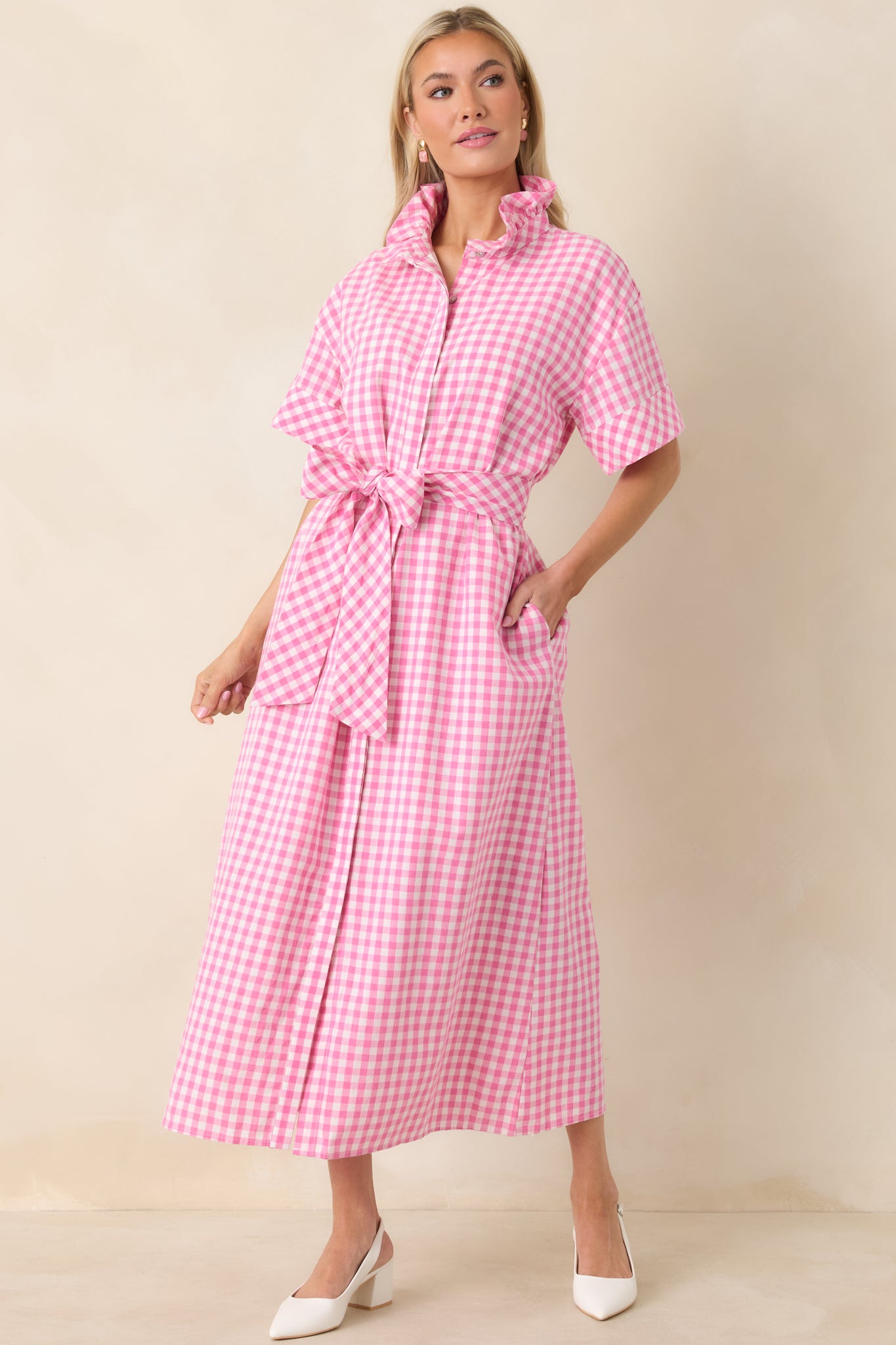 Pink and white gingham maxi dress with self-tie belt at the waist and graceful drape in the full-length skirt.