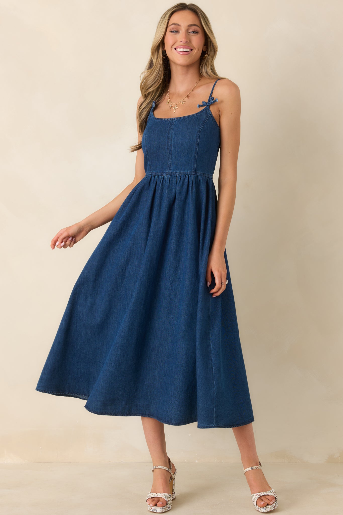 Fitted bodice midi dress in dark wash fabric, flowing into a gently gathered skirt with a comfortable pullover design.