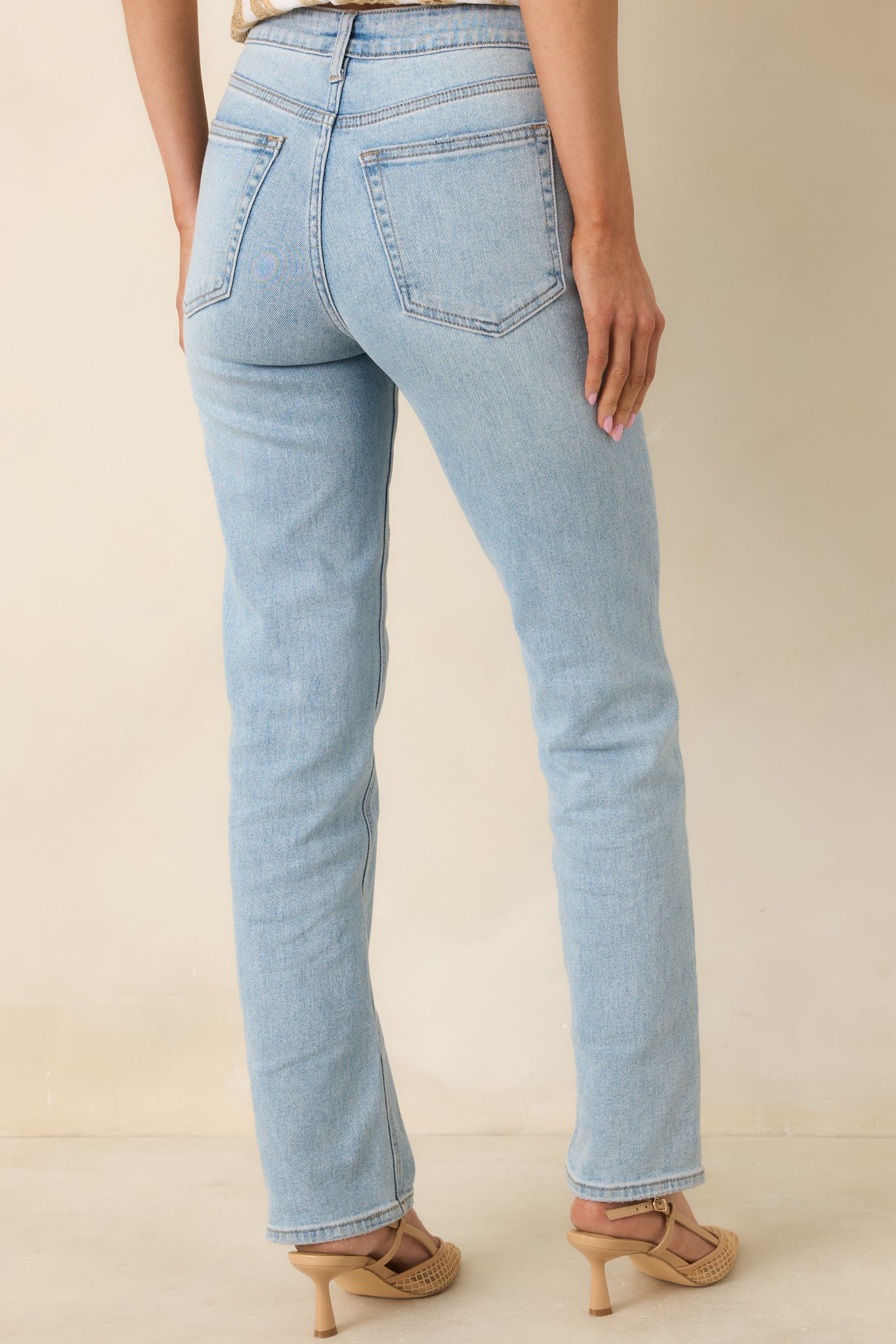 Rear view of straight-leg jeans showing back pockets, high-waisted design, and full-length leg shape.