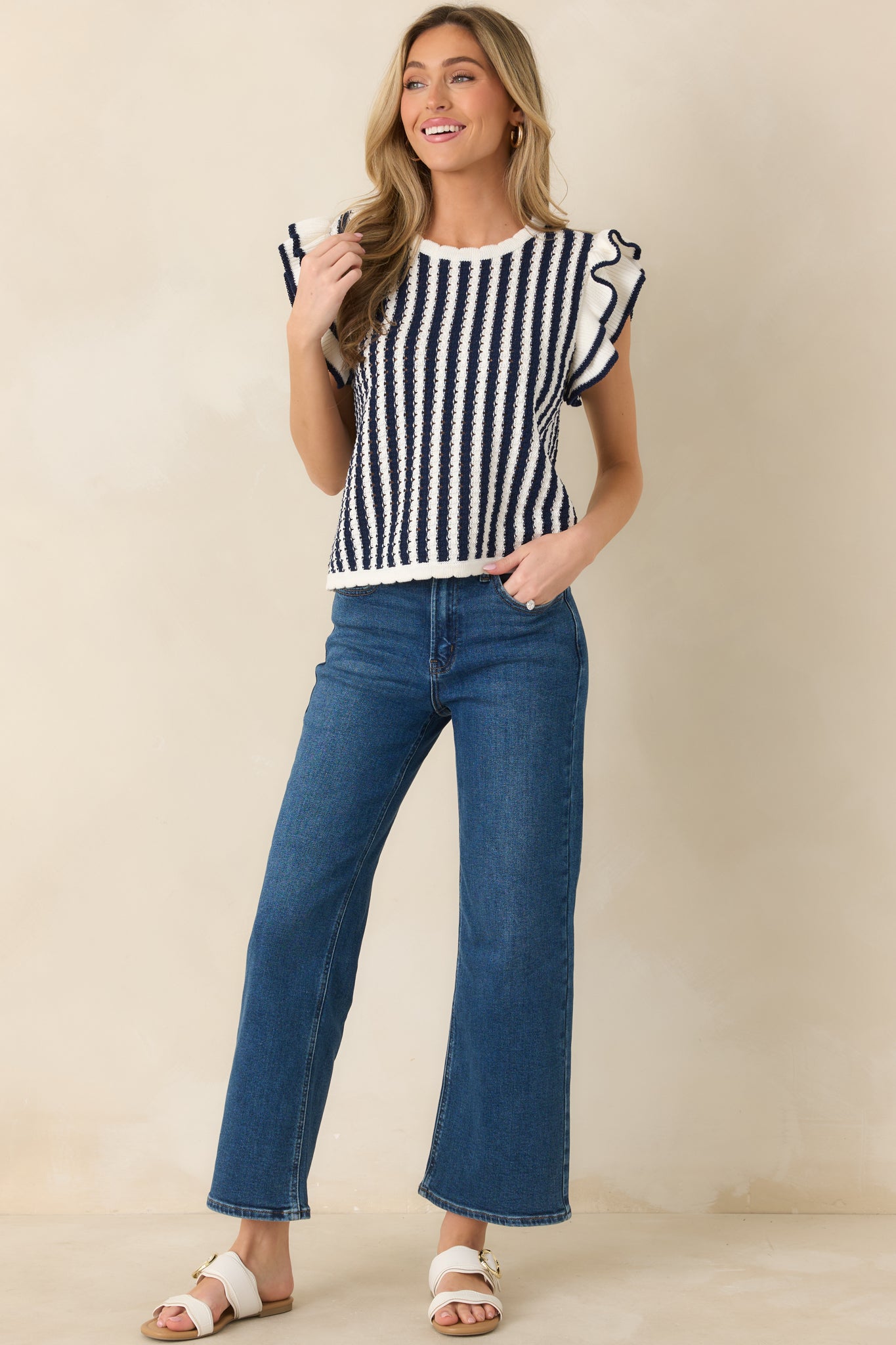 Lightweight striped top highlighting vertical lines and subtle hem scallop.
