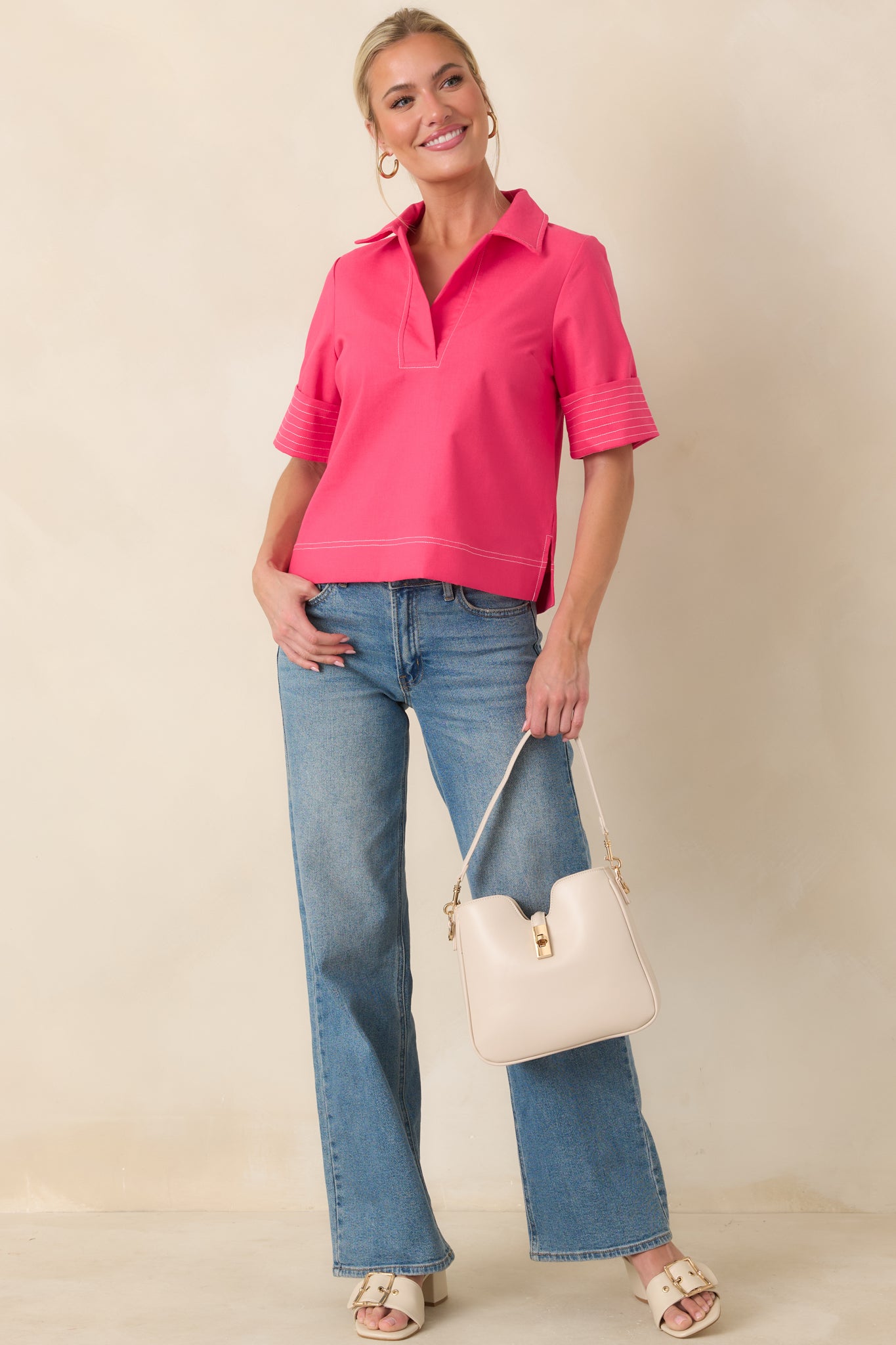 V-neck hot pink blouse with tailored collar, wide cuffed sleeves, and clean straight hemline.