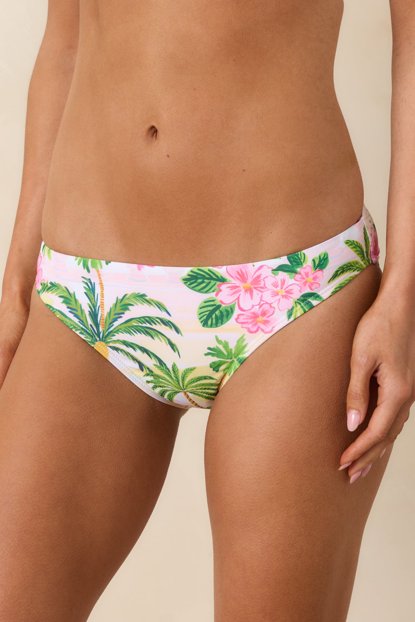 Close-up of bikini bottoms showing the vibrant poolside print, tropical motifs, and low-rise waist construction.