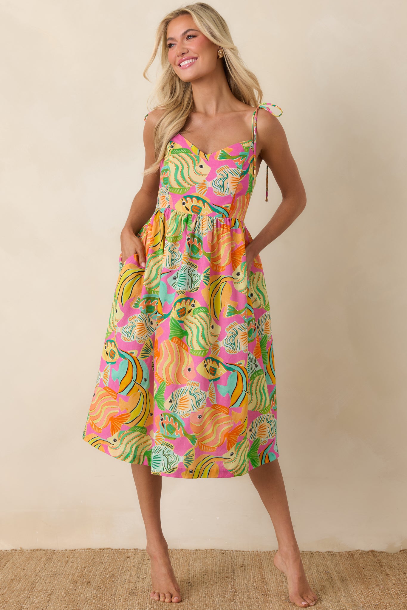 Vibrant fish-print midi dress with gathered bodice and breezy, relaxed skirt.