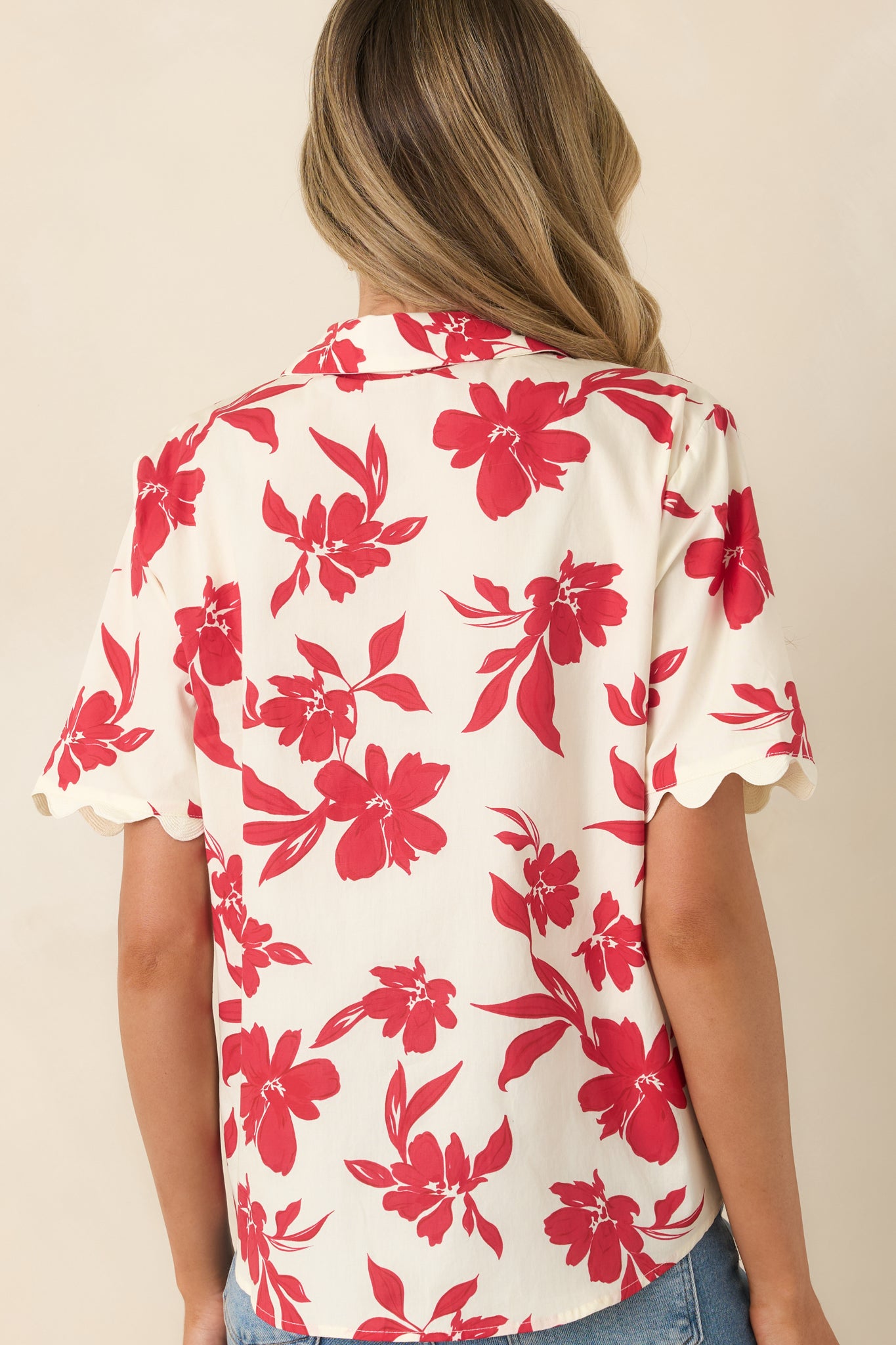 Ivory cotton top with vibrant red floral print and short sleeves.