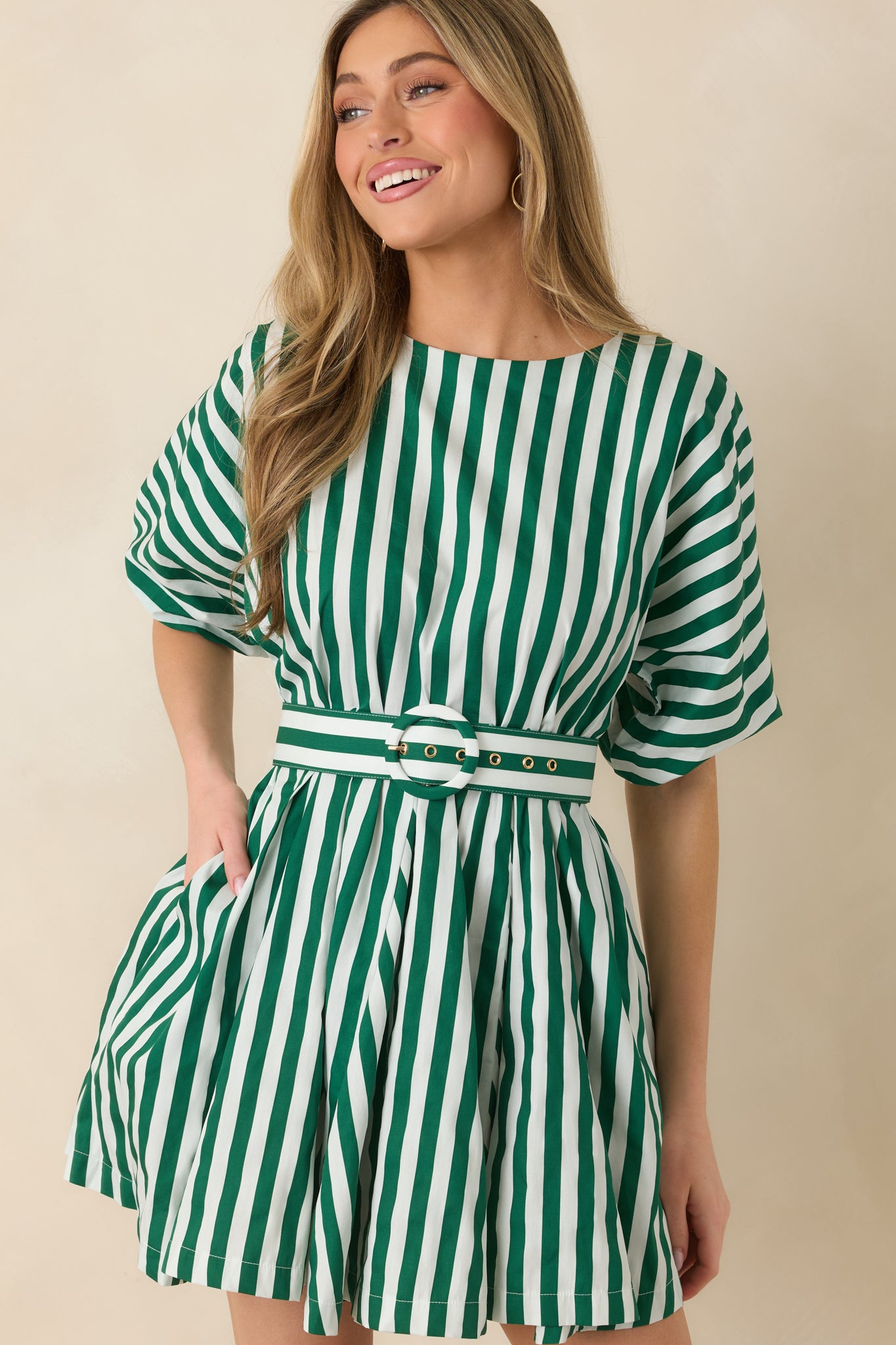 Detailed look at the vertical green and ivory stripes with the softly gathered puff sleeves and smooth neckline.