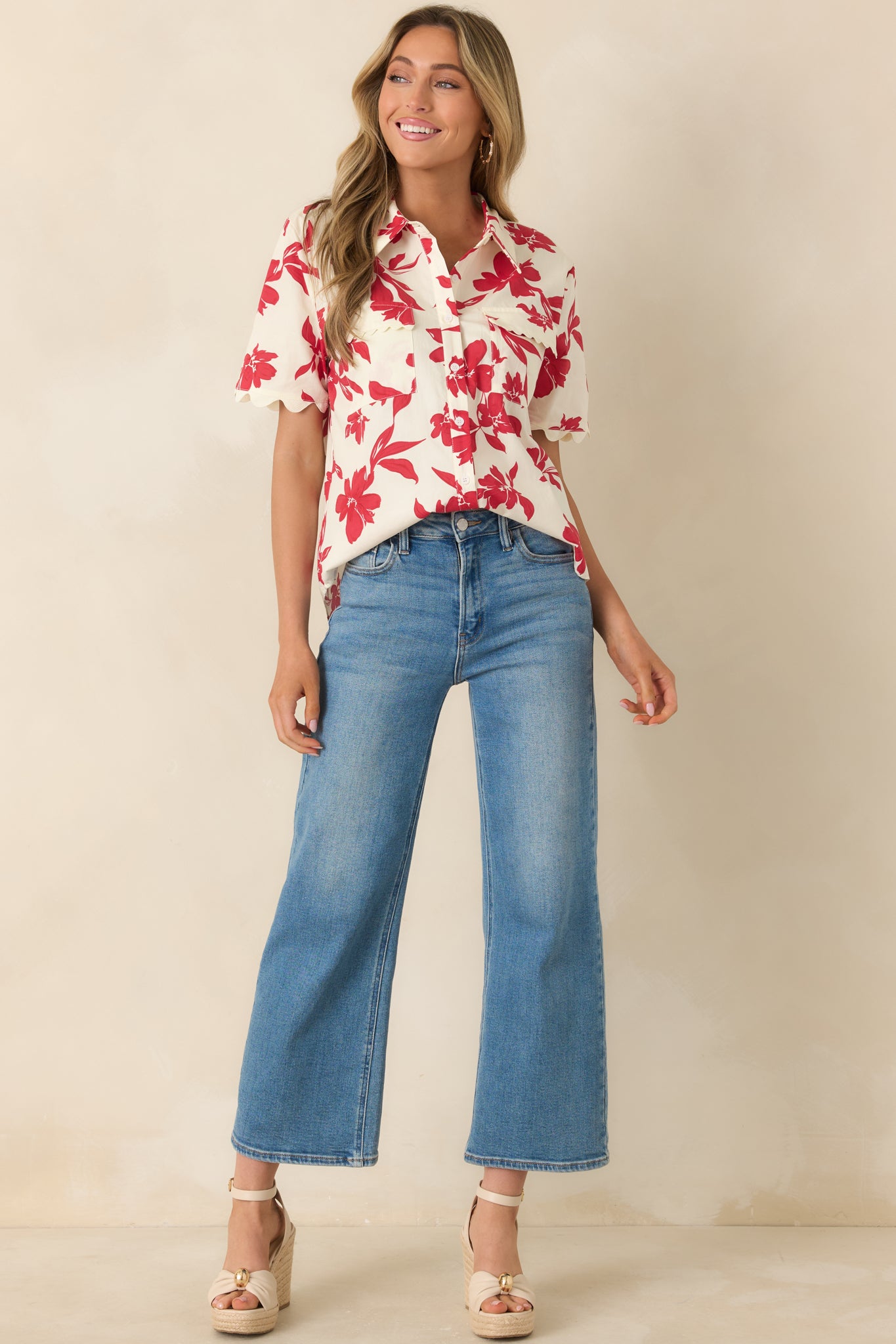 Lightweight ivory top featuring bold red florals, short sleeves, and classic collar.