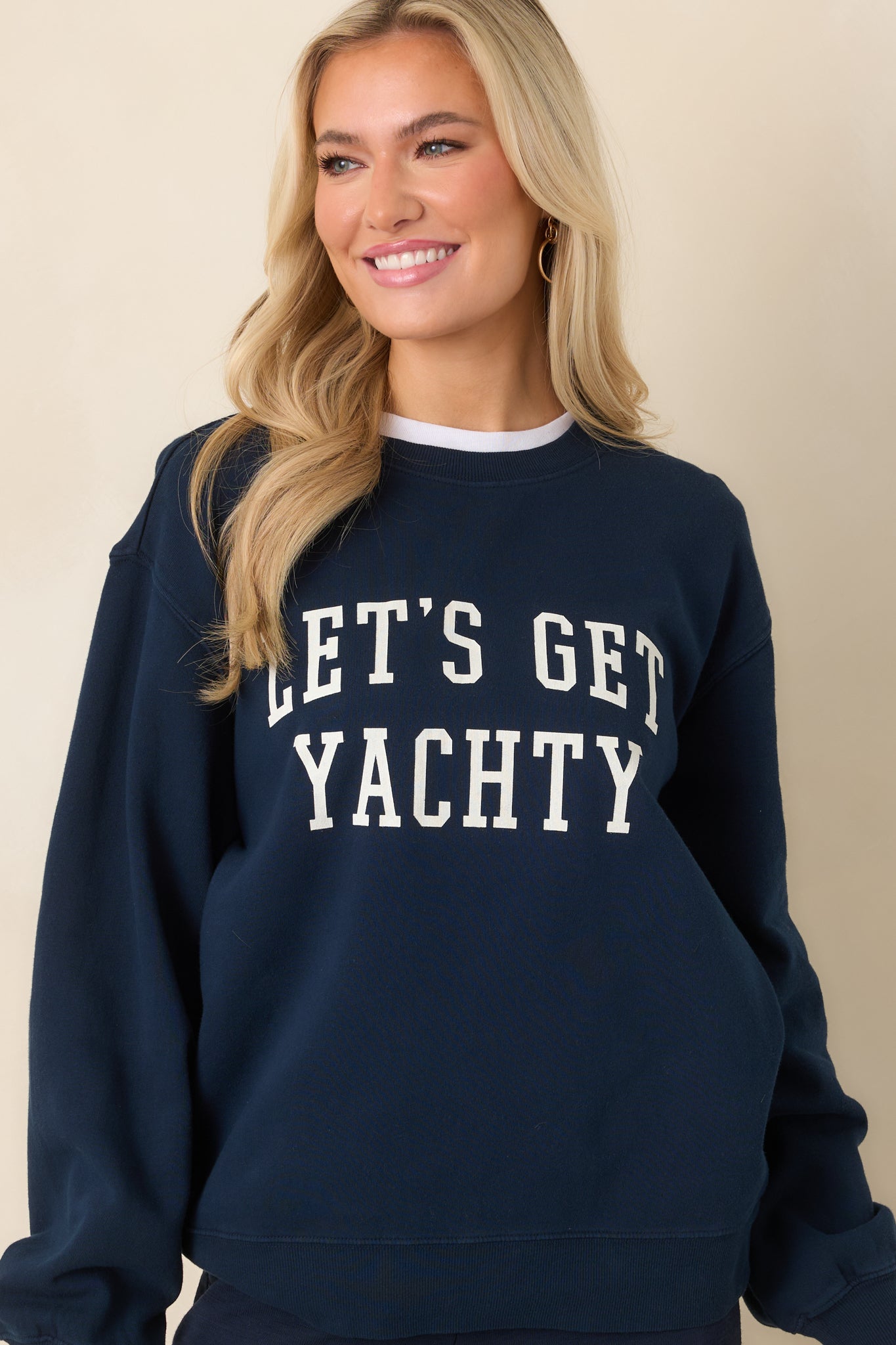 Cropped shot highlighting ribbed collar and soft cotton texture of navy sweatshirt.