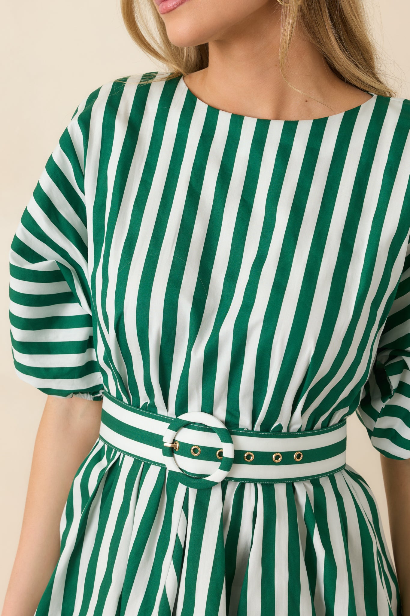 Close-up of the crisp green and ivory striped fabric highlighting the coordinating belt and clean vertical pattern.