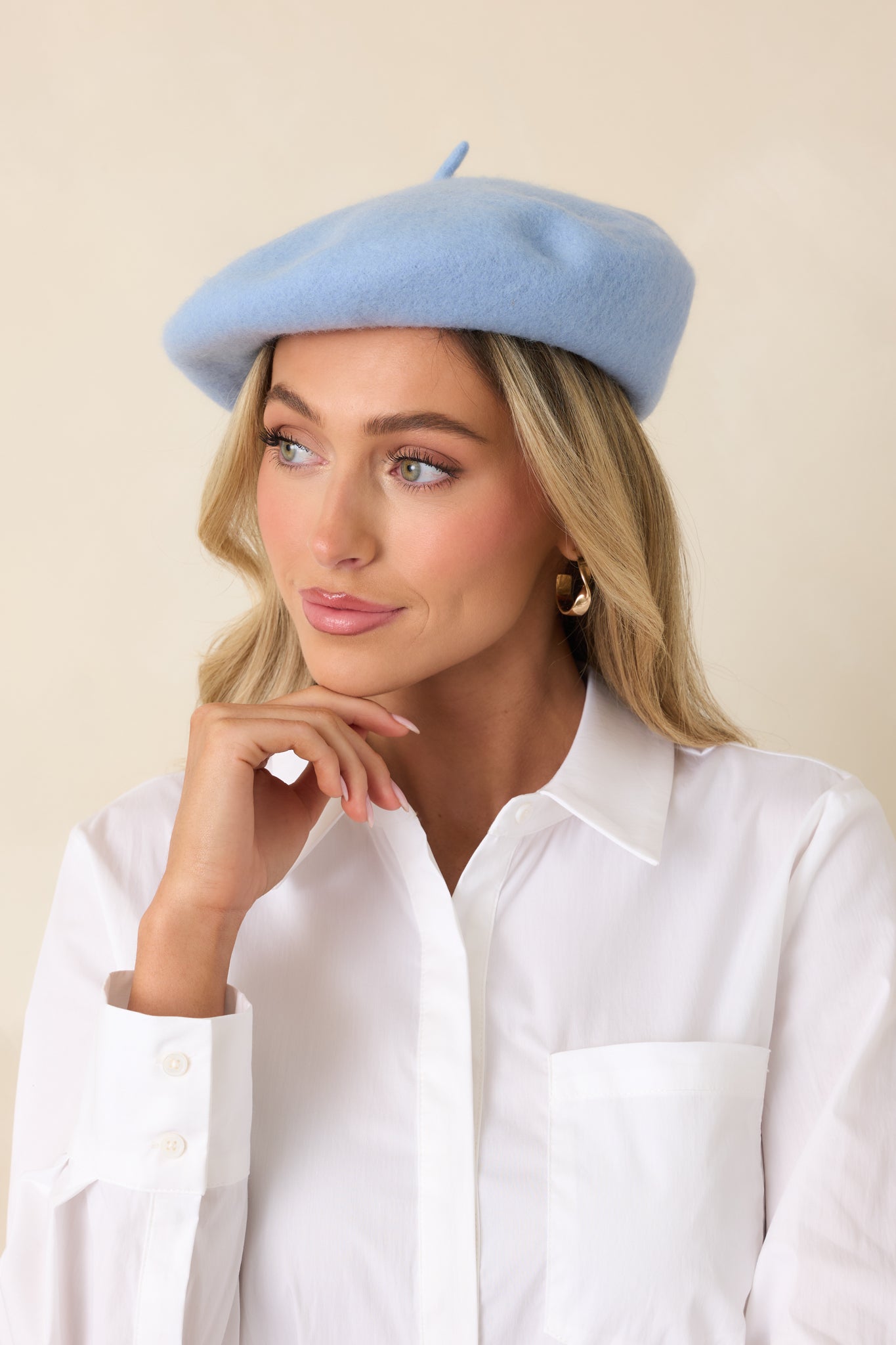Periwinkle wool beret with classic round silhouette and smooth, structured finish.