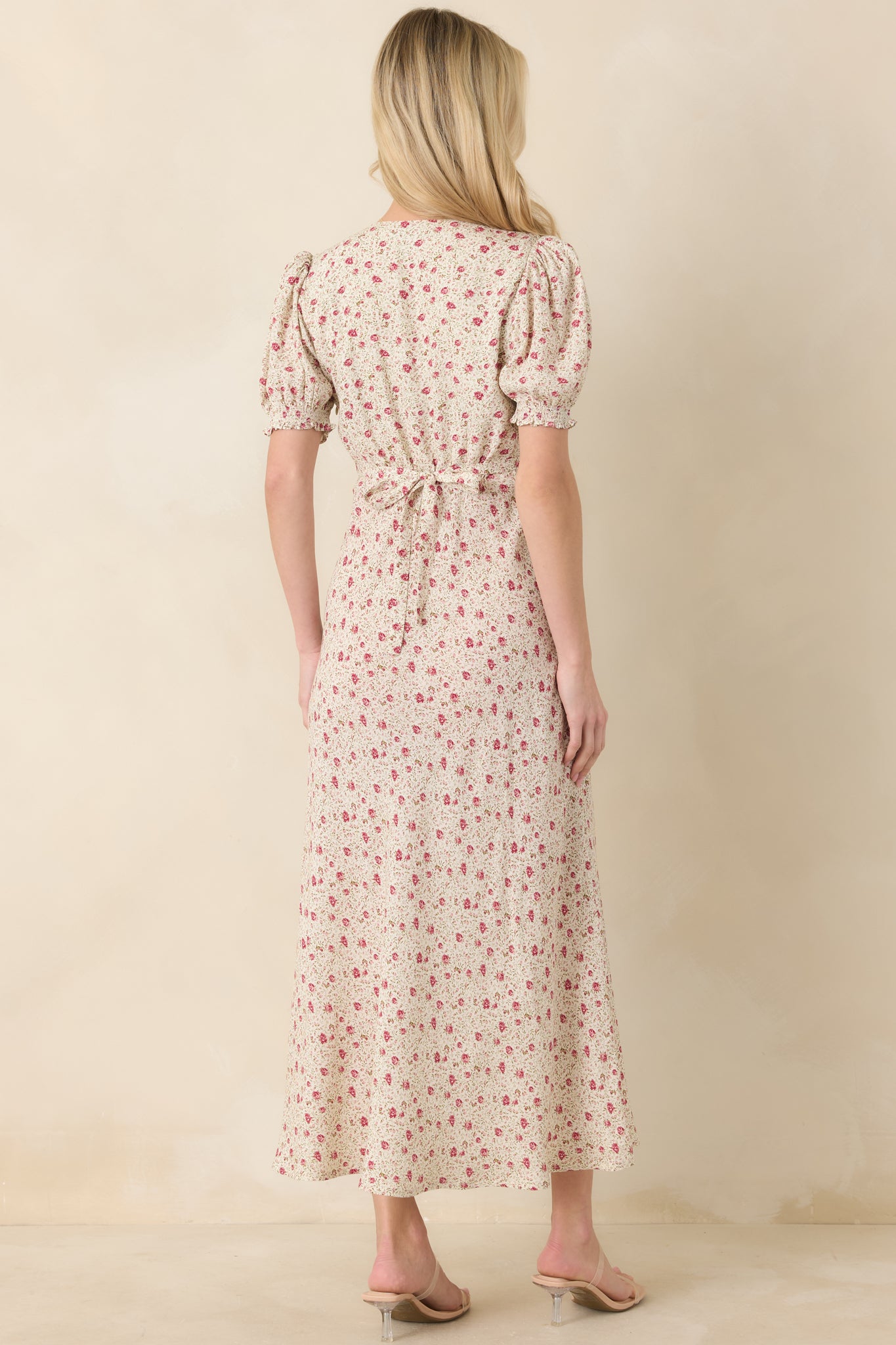 A rear view of the dress, highlighting the self-tie back, elastic waist, and the way the floral print continues throughout.