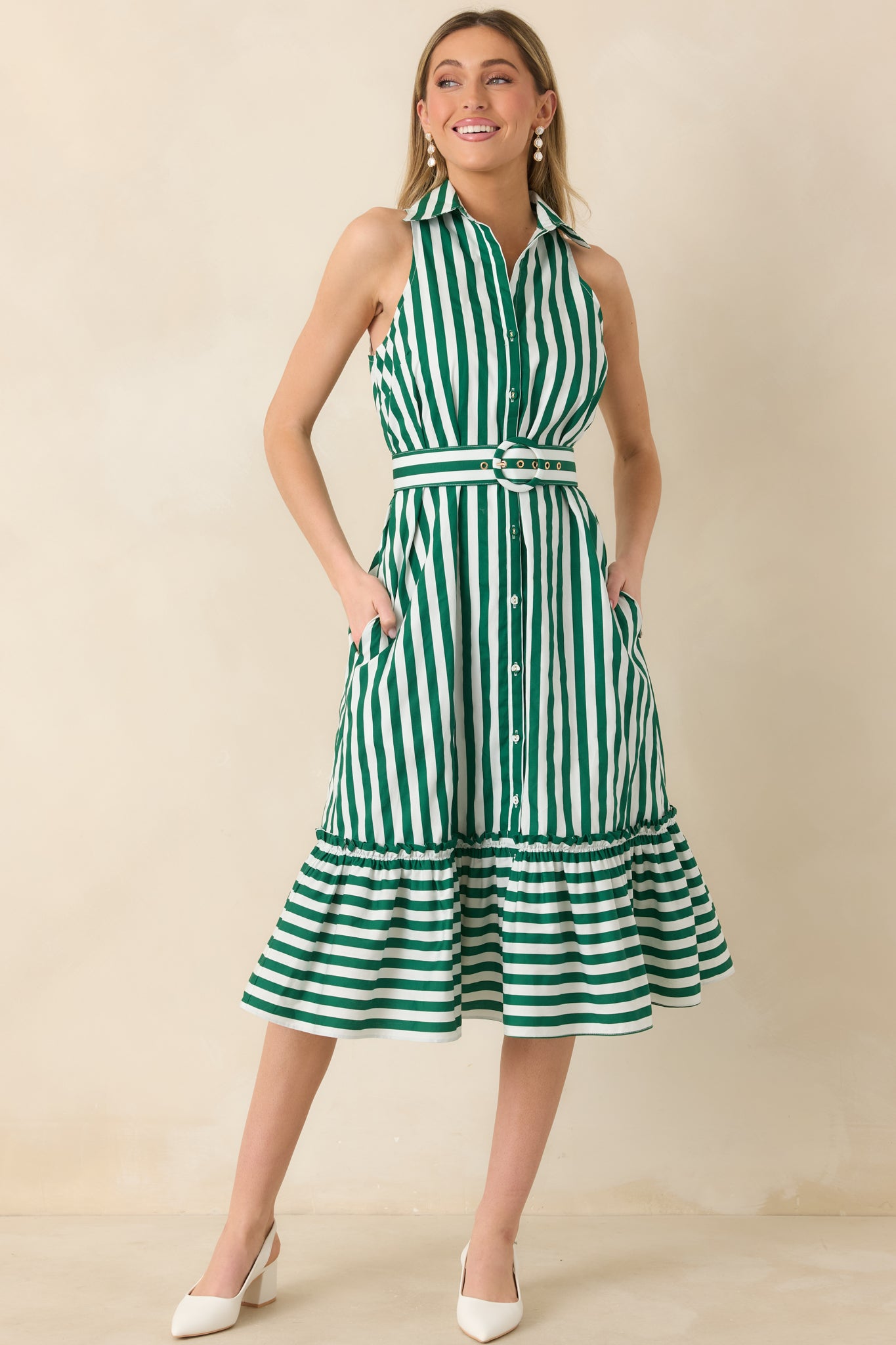 Green and ivory striped midi dress designed with a tailored collar, button-front bodice, coordinating waist belt, and a softly flared ruffle hemline.