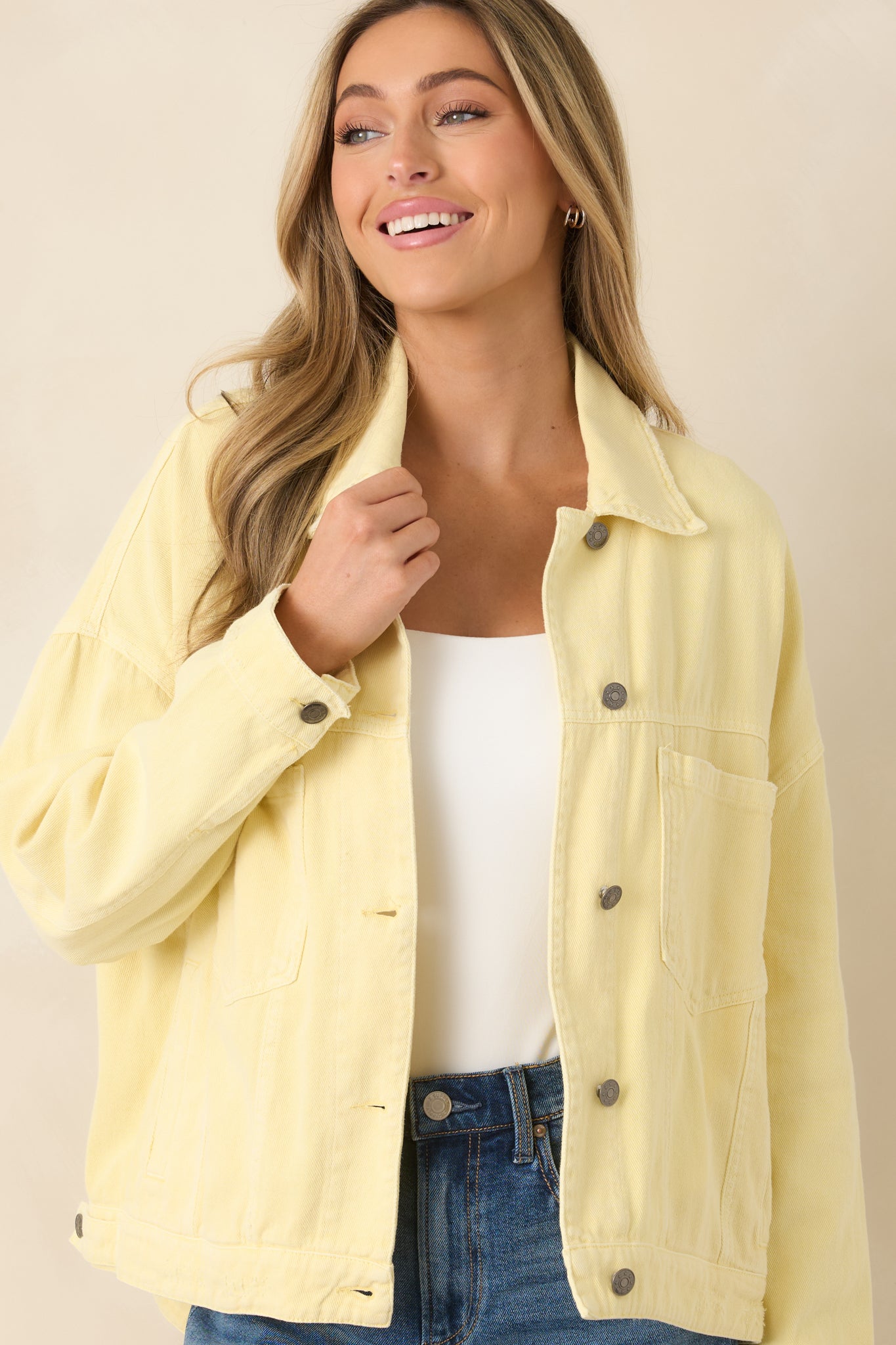 Detailed view of the structured collar and button-front closure, highlighting the sturdy denim fabric and clean topstitching.