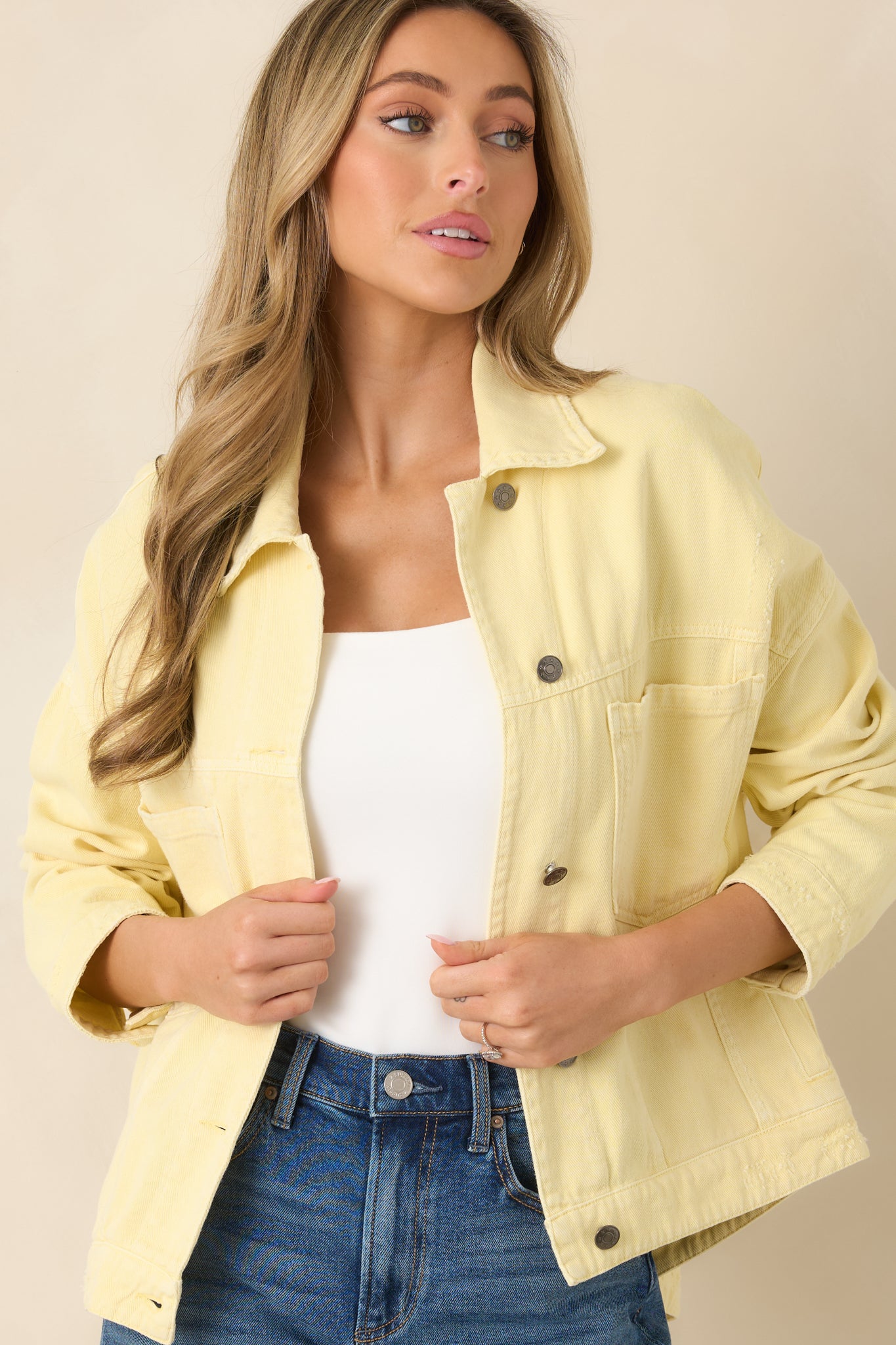 Closer look at the chest pockets with flap closures and metal buttons set against classic denim texture.