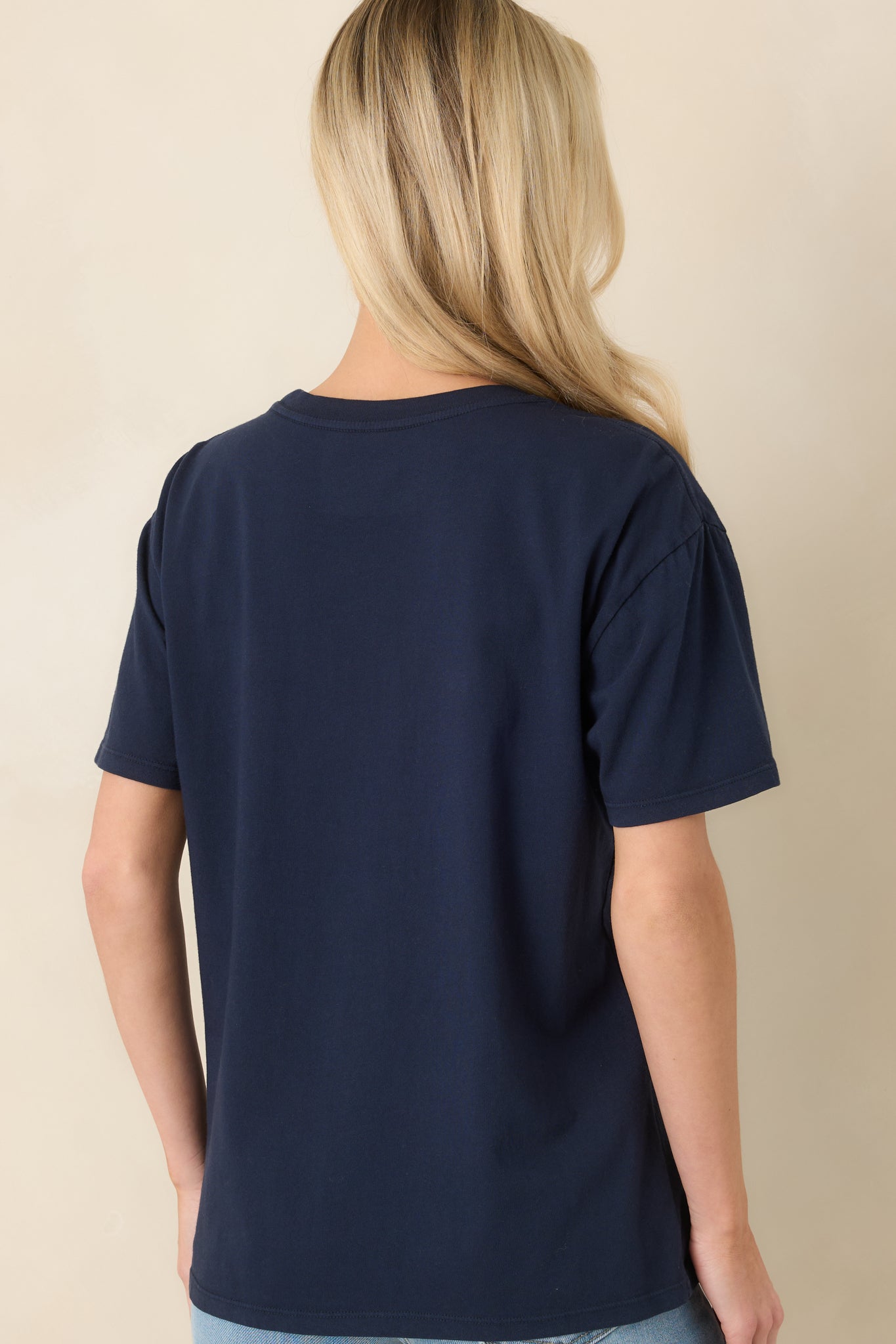 Rear view of the navy boyfriend-fit tee displaying a relaxed cut, short sleeves, and clean straight hem.