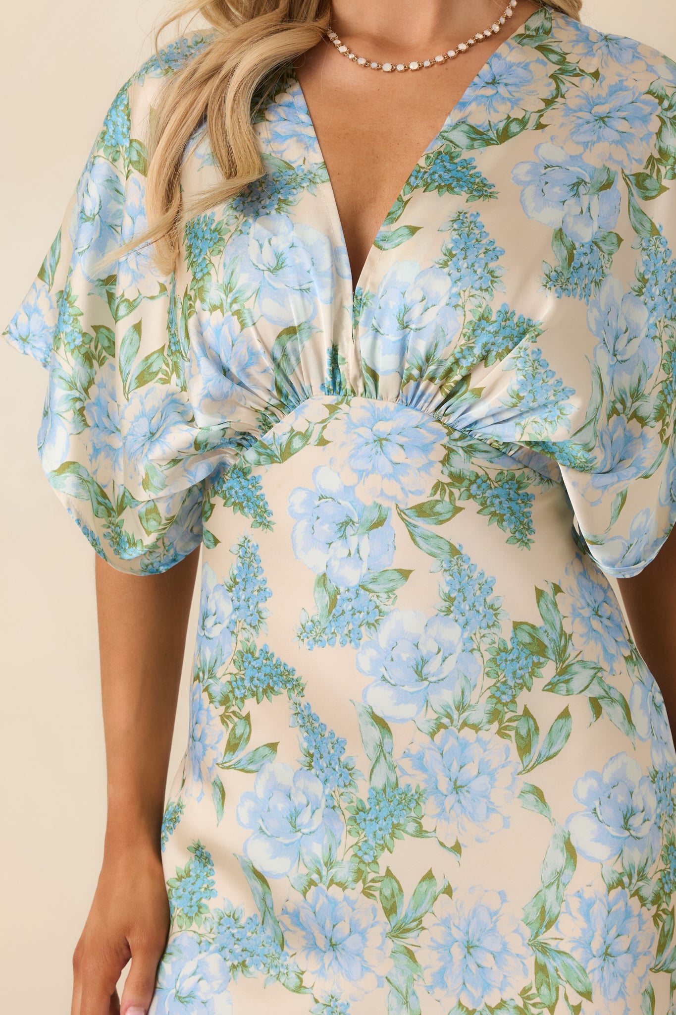 Close-up view of the sky blue dress focusing on the gathered empire waist and neckline detailing.