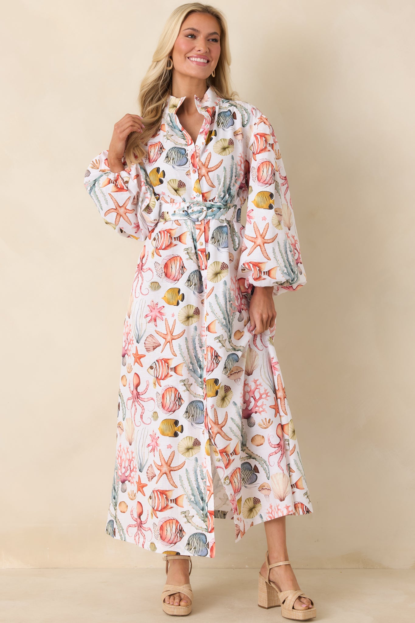 Full-length button-front dress with removable belt, gathered sleeve cuffs, and functional side pockets.