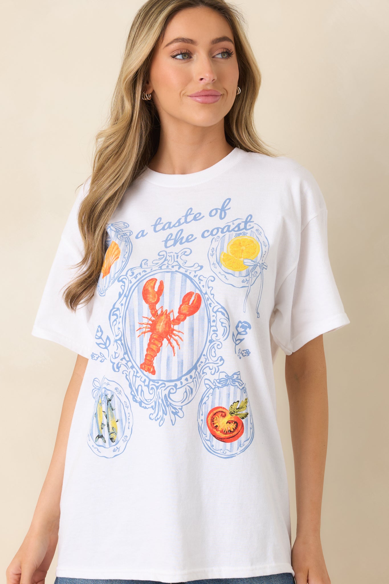 White short-sleeve tee with a crew neckline, relaxed fit, and a coastal multicolor screen print graphic.