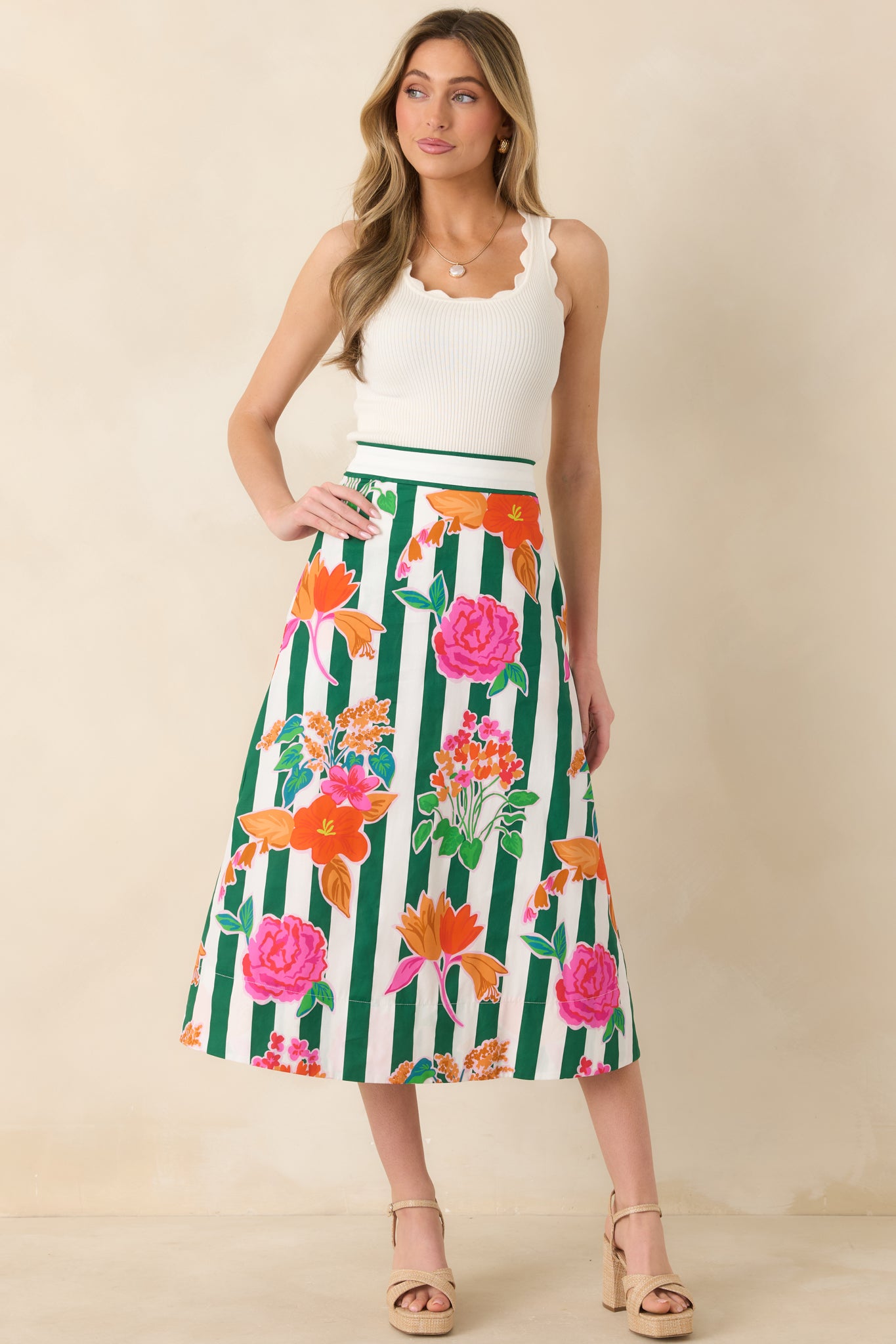 Cotton midi skirt with green vertical stripes and colorful floral print, designed with a flattering high waist and smooth, flowing silhouette.