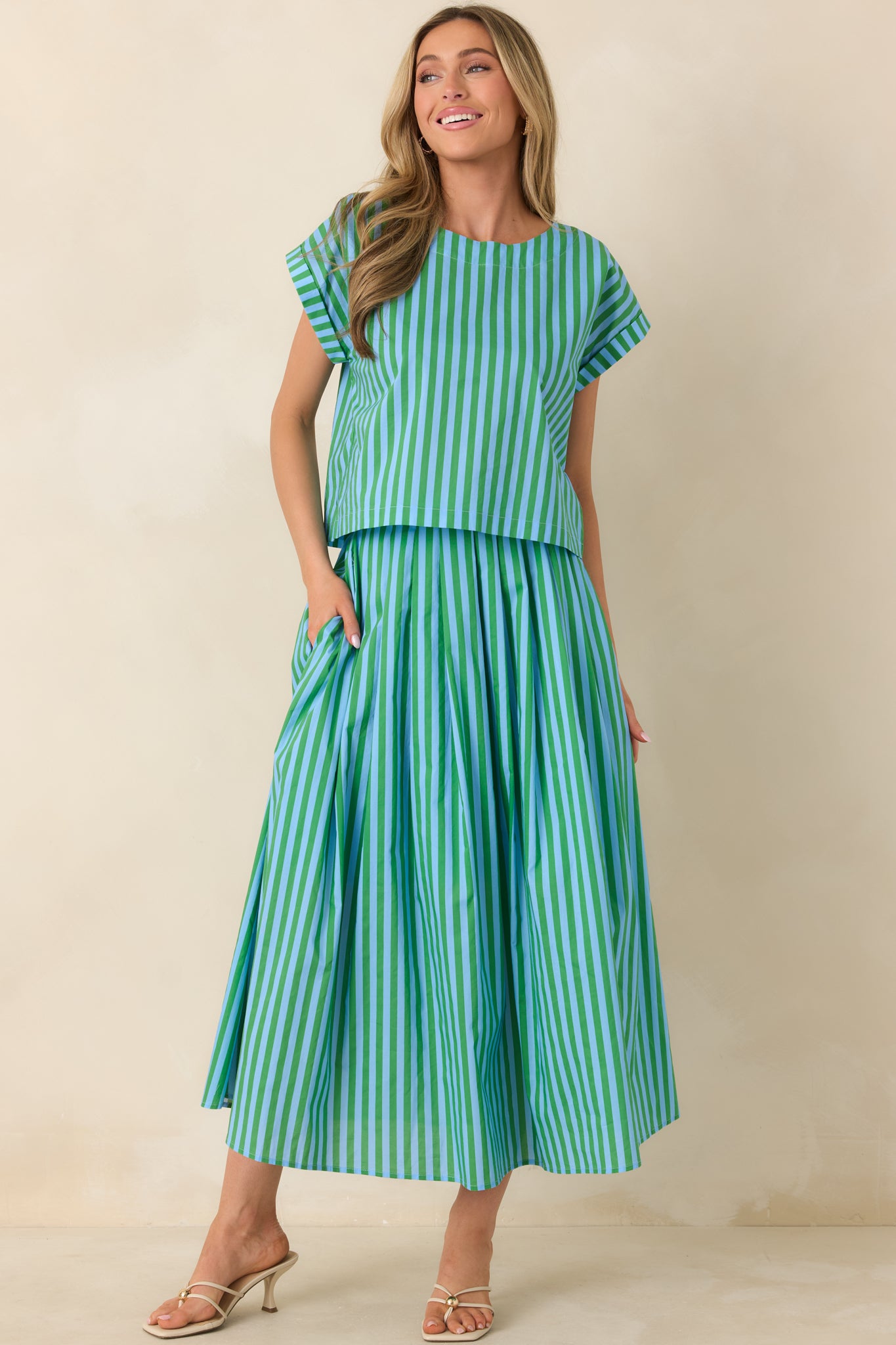 Relaxed-fit striped top featuring a slightly cropped hem, clean sleeve cuffs, and elongated vertical pattern.