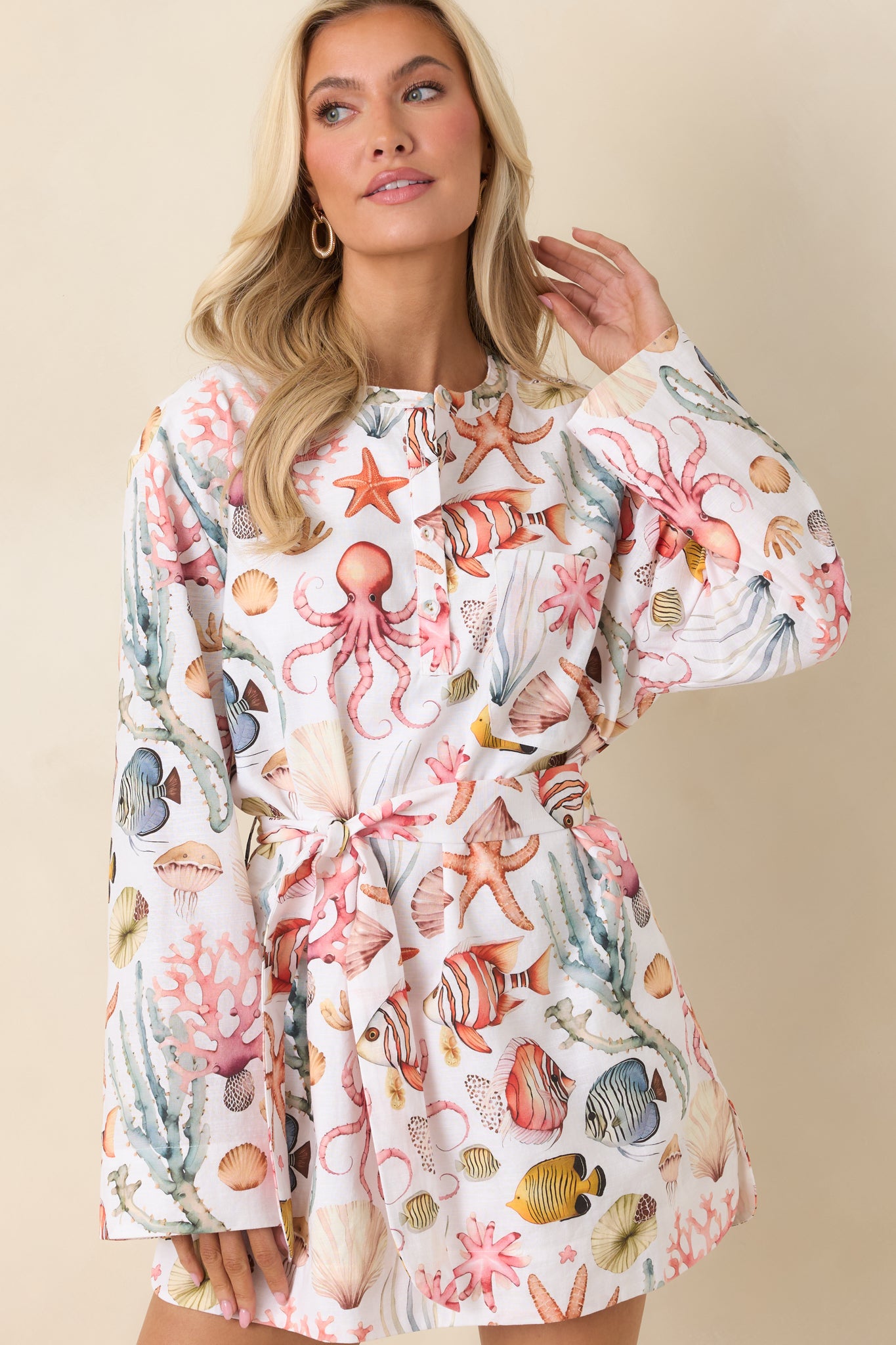 Roll-tab sleeve with cuff detail on breathable coastal-print mini dress.