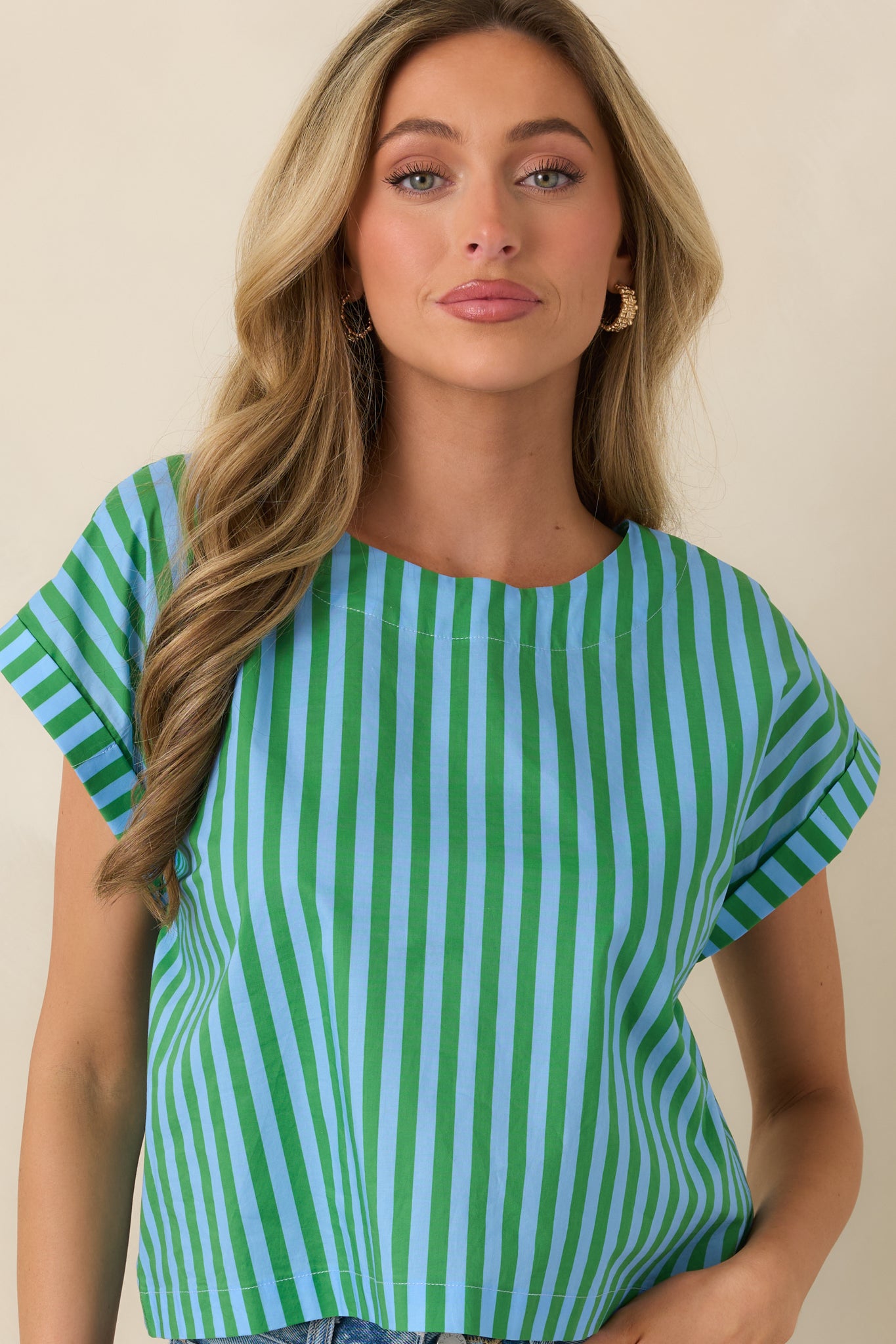 Detail of the short cuffed sleeves and structured fit of the boxy striped cotton top.