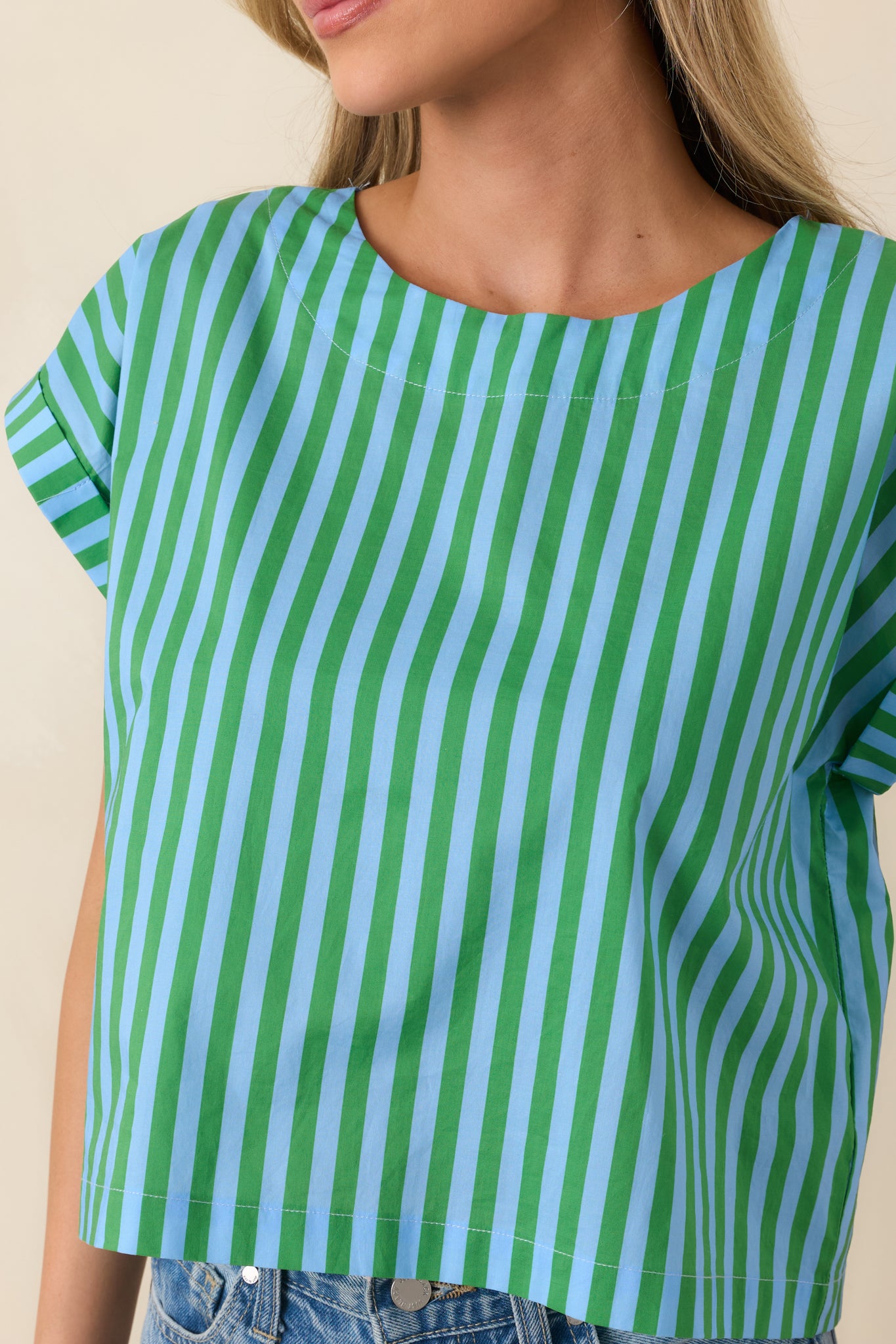 Close-up of the fabric showing the blue and green vertical stripes, clean finishes, and structured neckline.