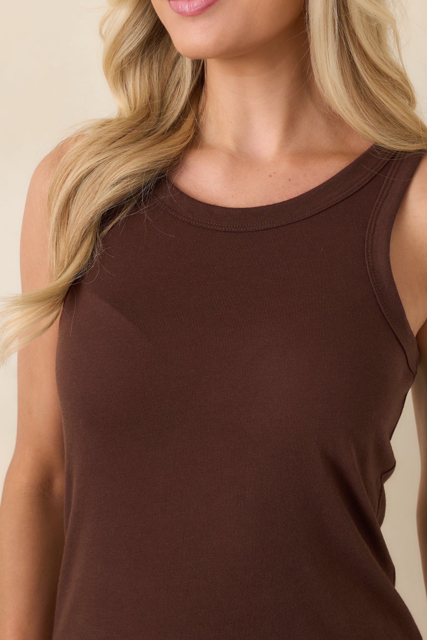 Close-up of brown tank top fabric showcasing the lightweight cotton-blend texture and stitching.