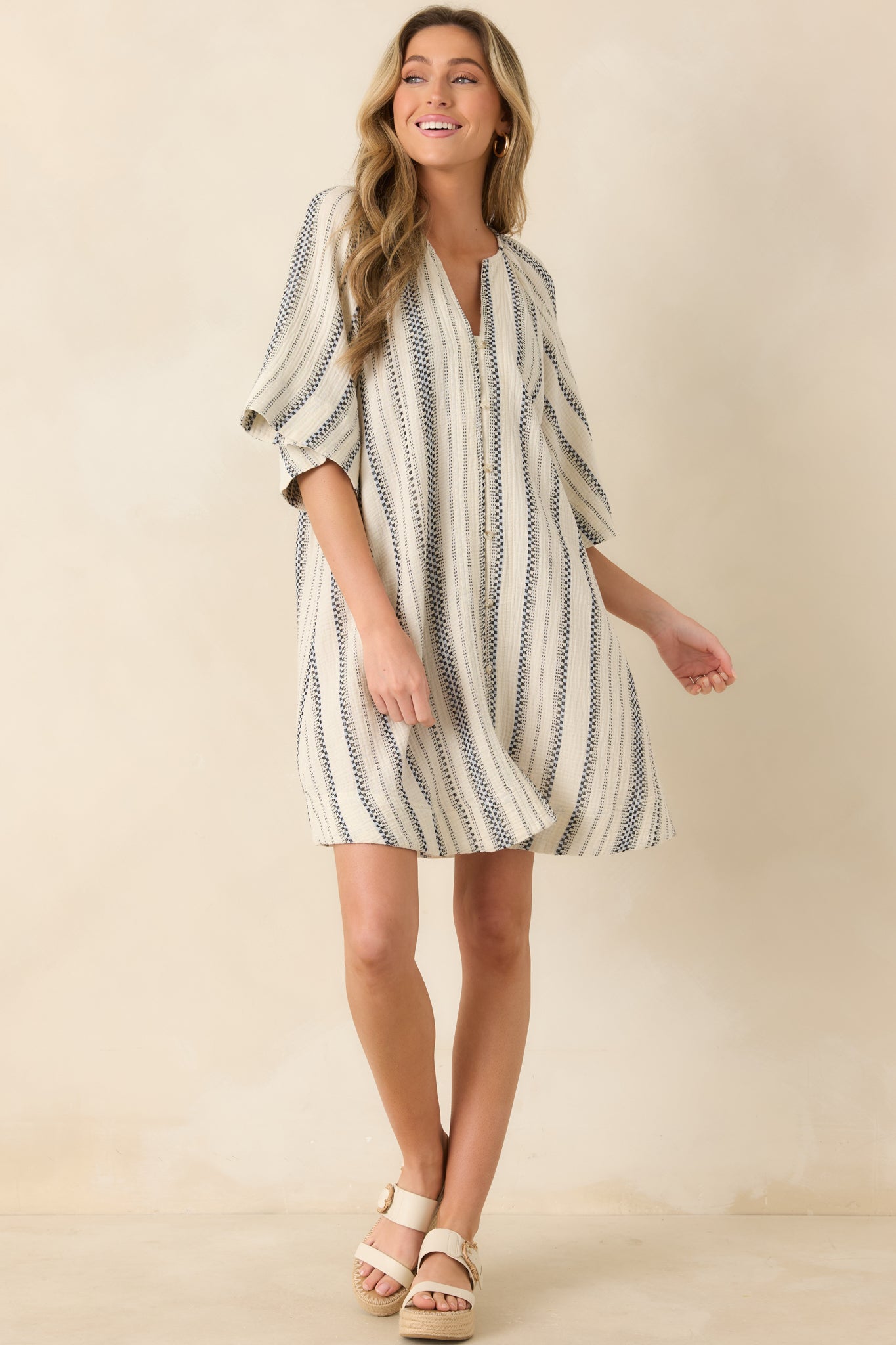 Ivory and black striped mini dress with relaxed oversized silhouette and split neckline.