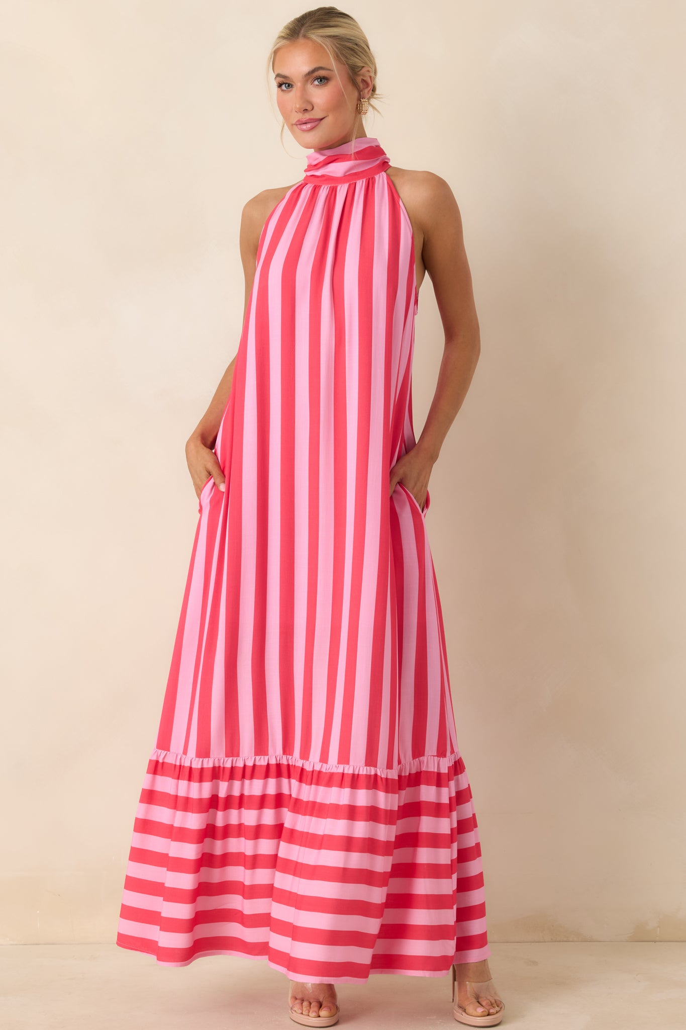 Vertical fuchsia and pink stripe dress featuring a halter neckline and easy, breezy fit.