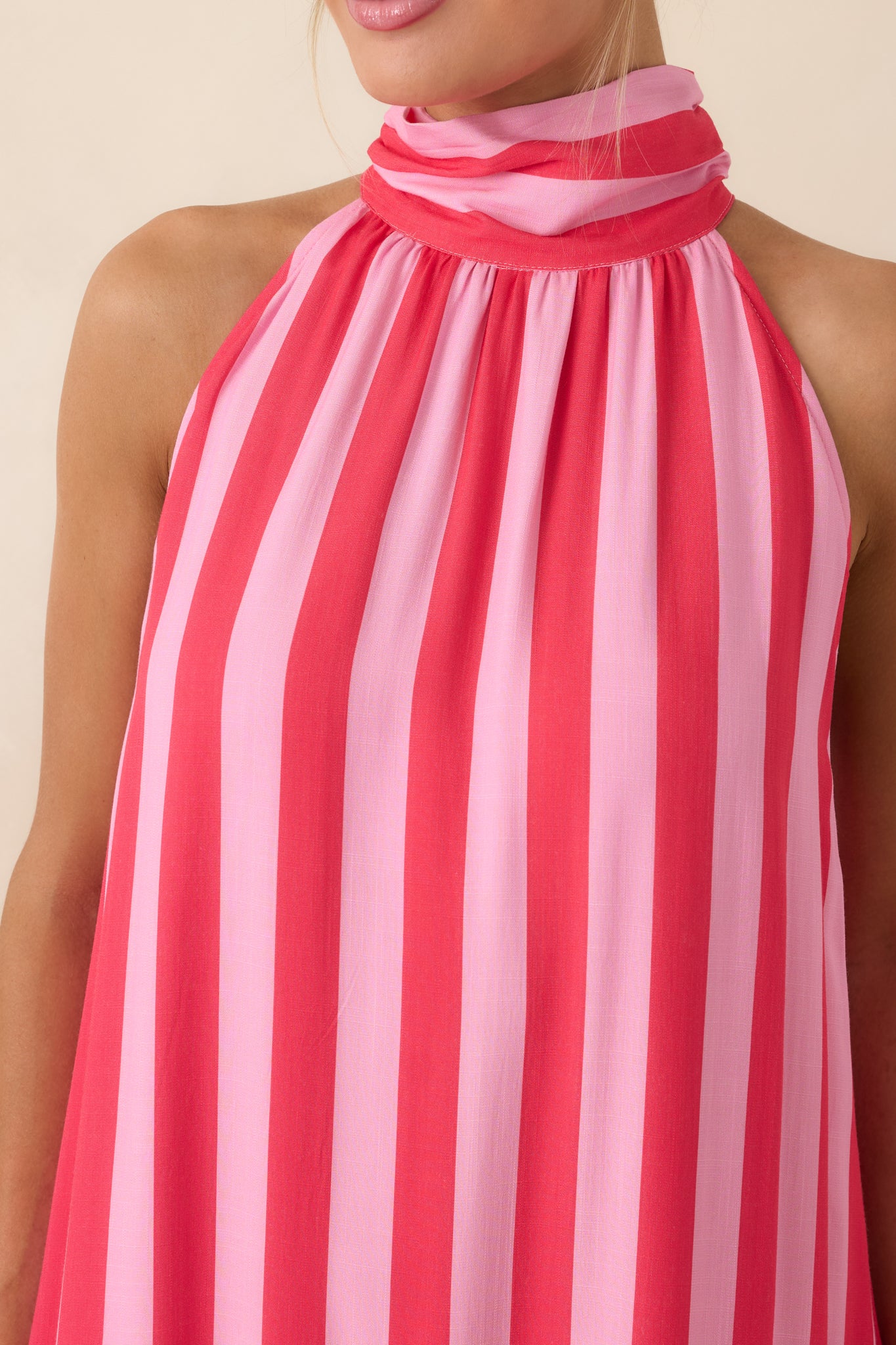 Close view of fuchsia and light pink stripes with gathered neckline detail and contrasting horizontal tier.