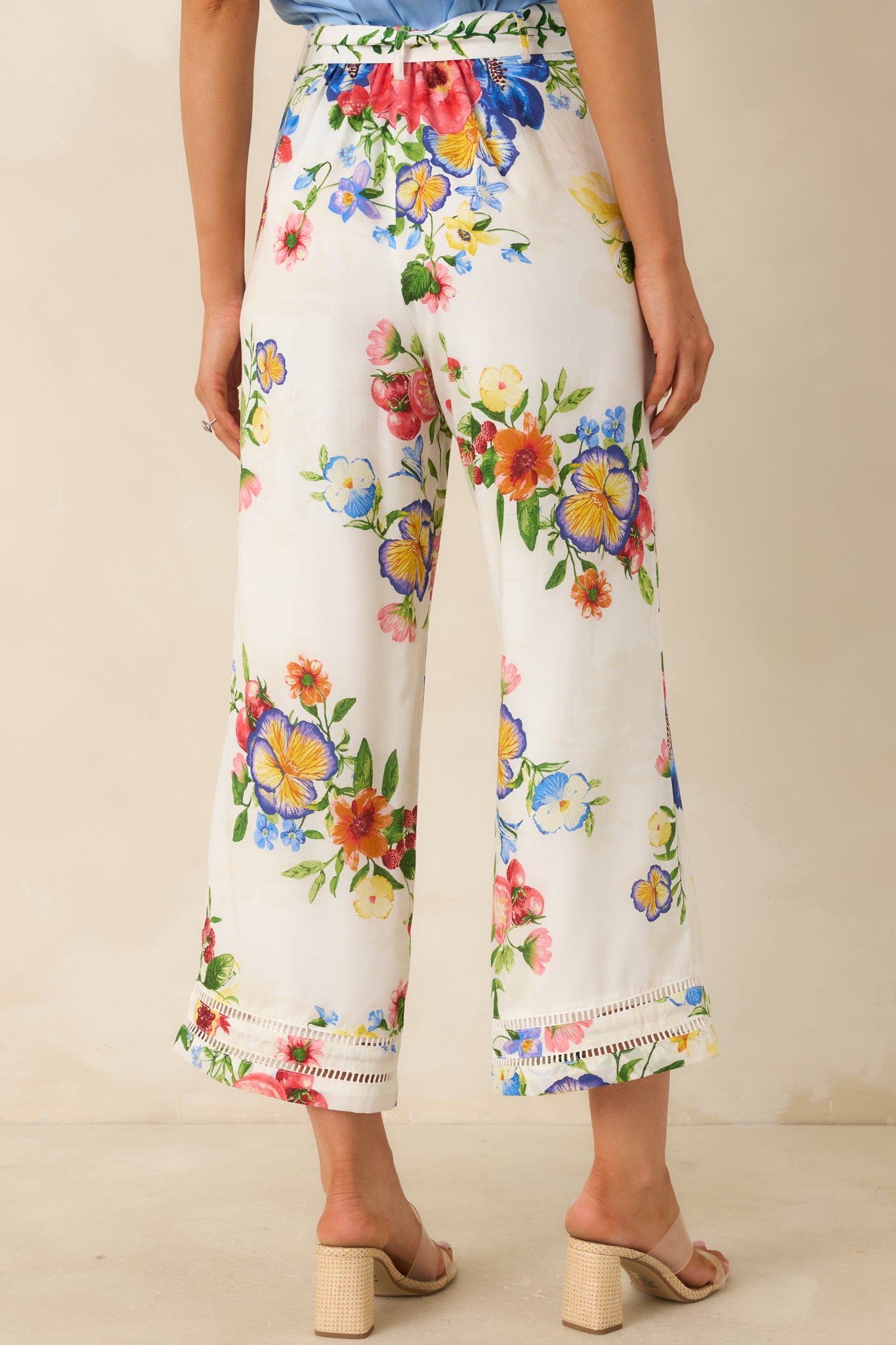 Rear view of botanical print cropped wide leg pants with relaxed, flowing silhouette.