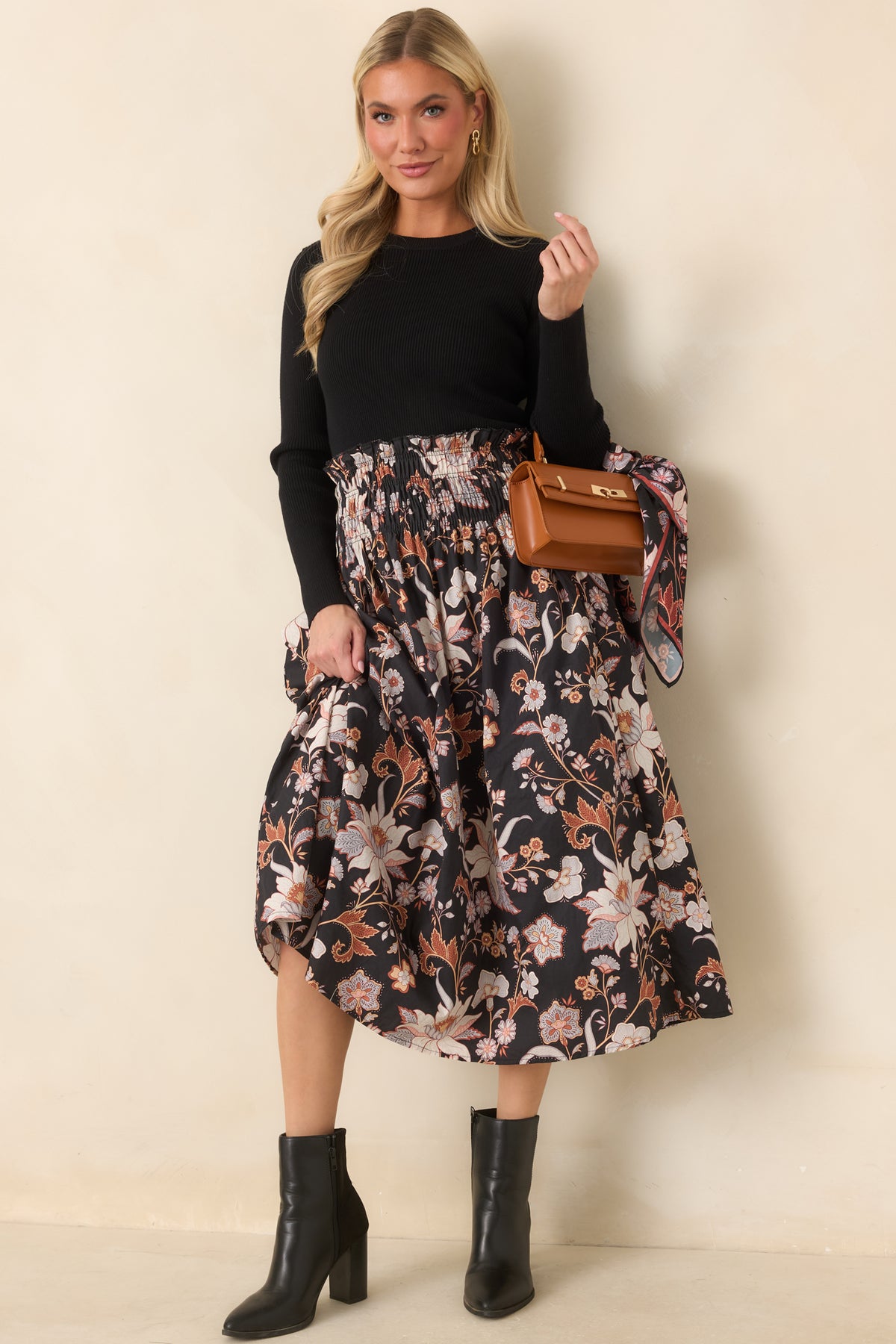 Ivory and blush flowers with rust and periwinkle accents decorate this black cotton skirt with a flowing midi-length silhouette.
