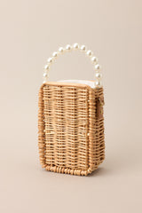Bamboo rectangular handbag with a pearl strap and drawstring closure.