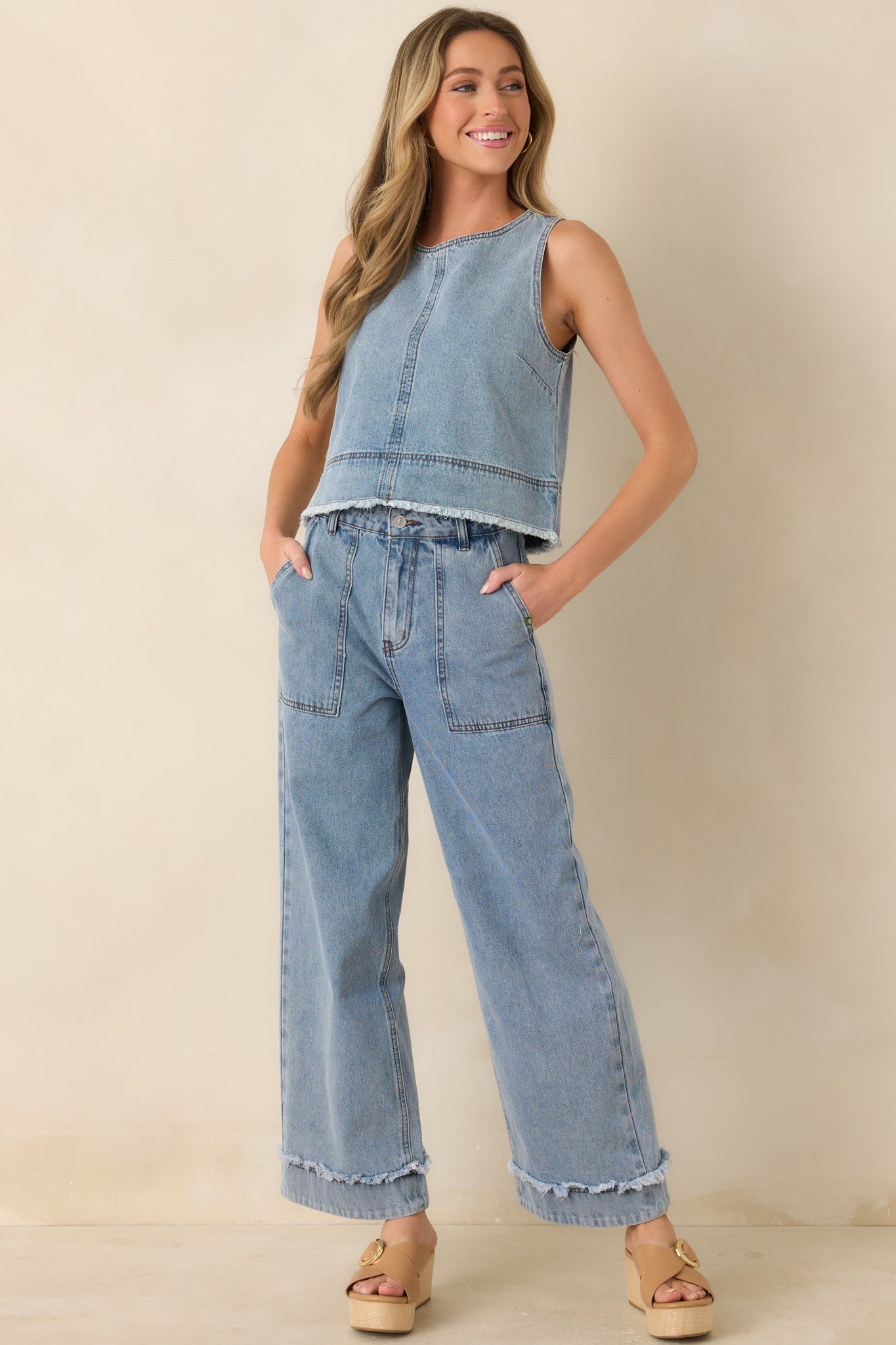 Light wash denim jeans, with a high-rise fit, wide leg silhouette, and utility-inspired front patch pockets.